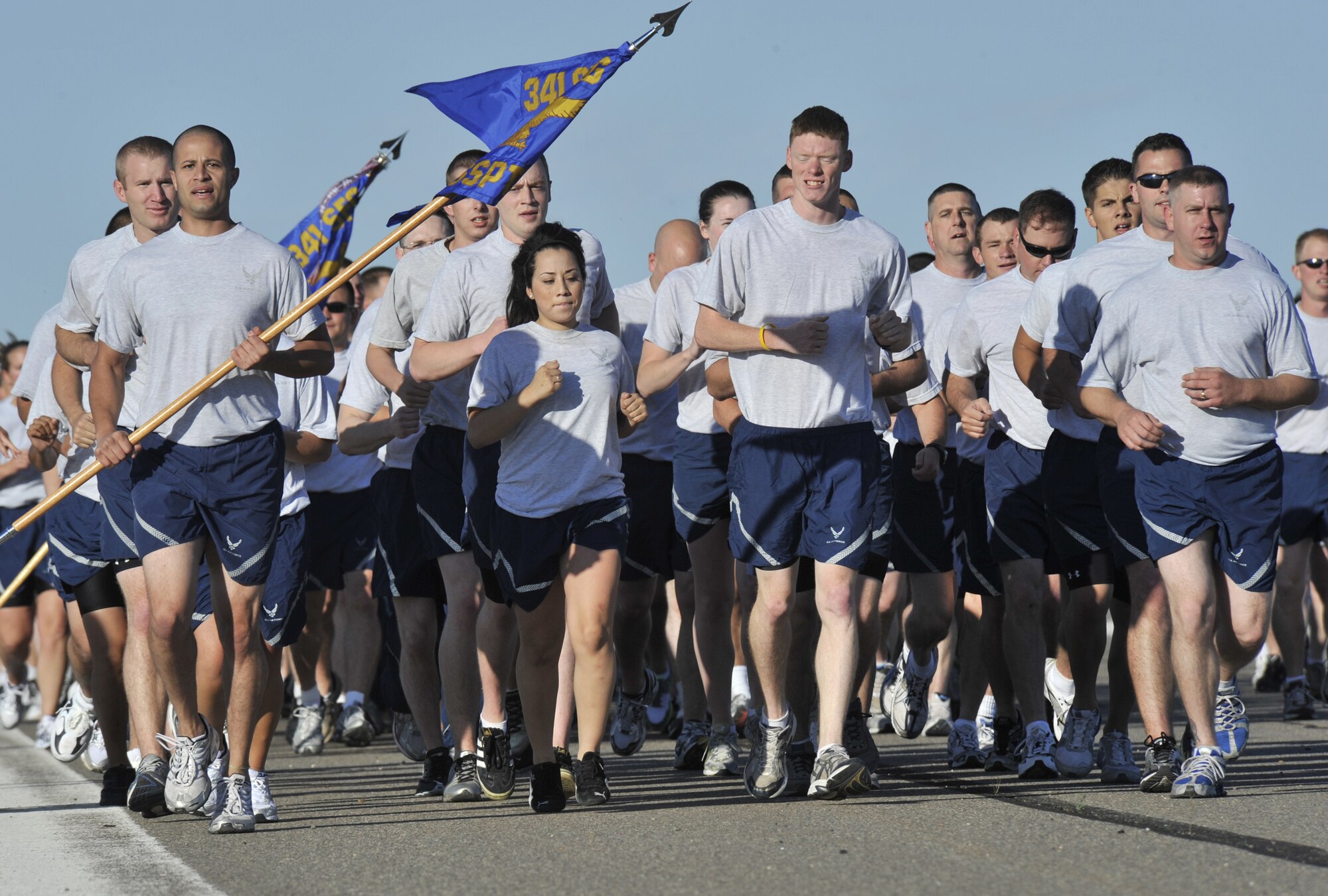 Members of the various security forces squadrons run in formation during the base-wide 5K military fun run July 1 on the flight line. (U.S. Air Force photo/John Turner)