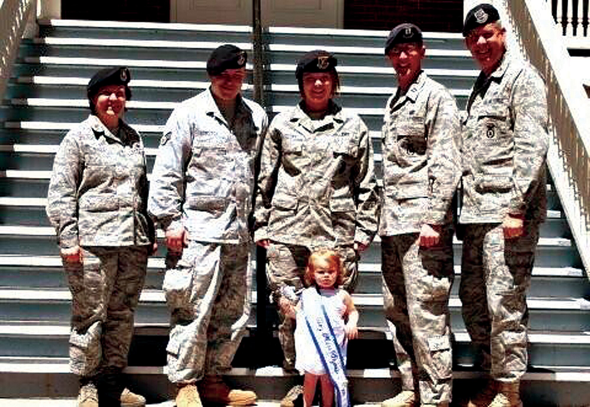 Maj. Beverly Baker, former 90th Security Forces Squadron commander; Senior Airman Justin Gorczyca, 90th SFS;  Staff Sgt. Heather Guillory, 90th Security Support Squadron; Capt. Kevin McMahon, 90th SSPTS commander; and Col. Steve Miller 90th Security Forces Group commander, pose with Tatum Gorczyca, this year’s “Tiny Miss Wyoming” in front of the Security Forces Group headquarters building. Tatum is the youngest and first representative of Cheyenne to hold a state title. (U.S. Air Force photo by Senior Airman Kristina Buckholz)