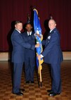 Col. Richard Houghton takes command of the 802nd Mission Support Group by accepting the guidon from Brig. Gen. Leonard Patrick, 502nd Air Base Wing commander, during a change of command ceremony July 7. (U.S. Air Force photo/Alan Boedeker)