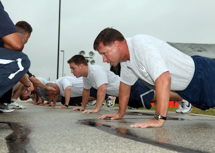 Brig. Gen. Leonard Patrick, 502nd Air Base Wing commander, completes the one-minute push-up assessment during his physical fitness test on the first official day of the revised program July 1. (U.S. Air Force photo/Robbin Cresswell)  