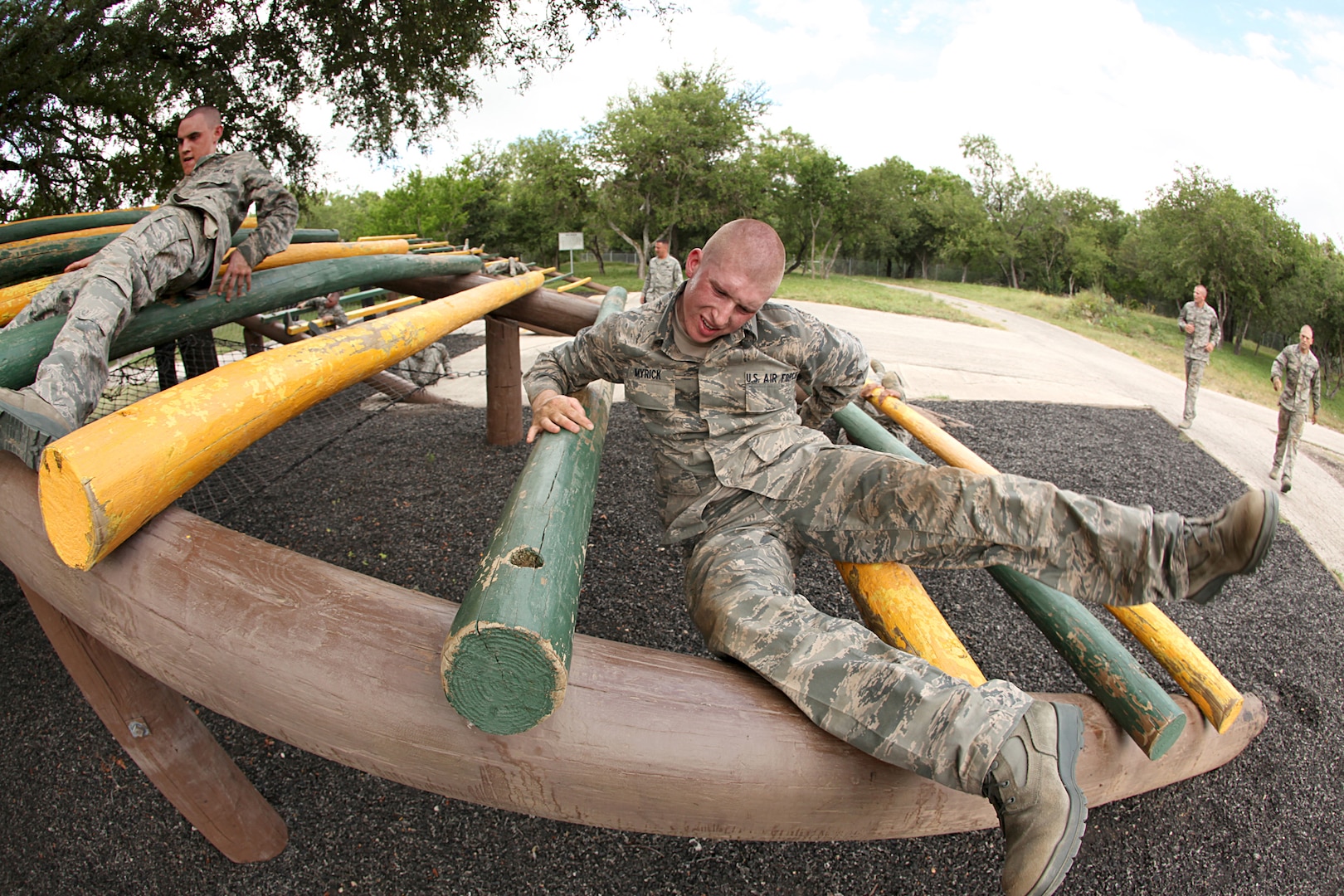 Trainees from basic miiltary training navigate an obstacle June 30. In addition to fitness training and military studies, Air Force basic military training trainees are taught foundational Air Force information including core values, customs and courtesies, and basic policies and procedures. (U.S. Air Force photo/Robbin Cresswell)