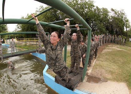 Air Force Basic Military Training trainees begin the monkey bars obstacle June 30. In BMT, trainees learn the critical importance of discipline, teamwork and foundational knowledge needed to succeed as an Airman. (U.S. Air Force photo/Robbin Cresswell)
