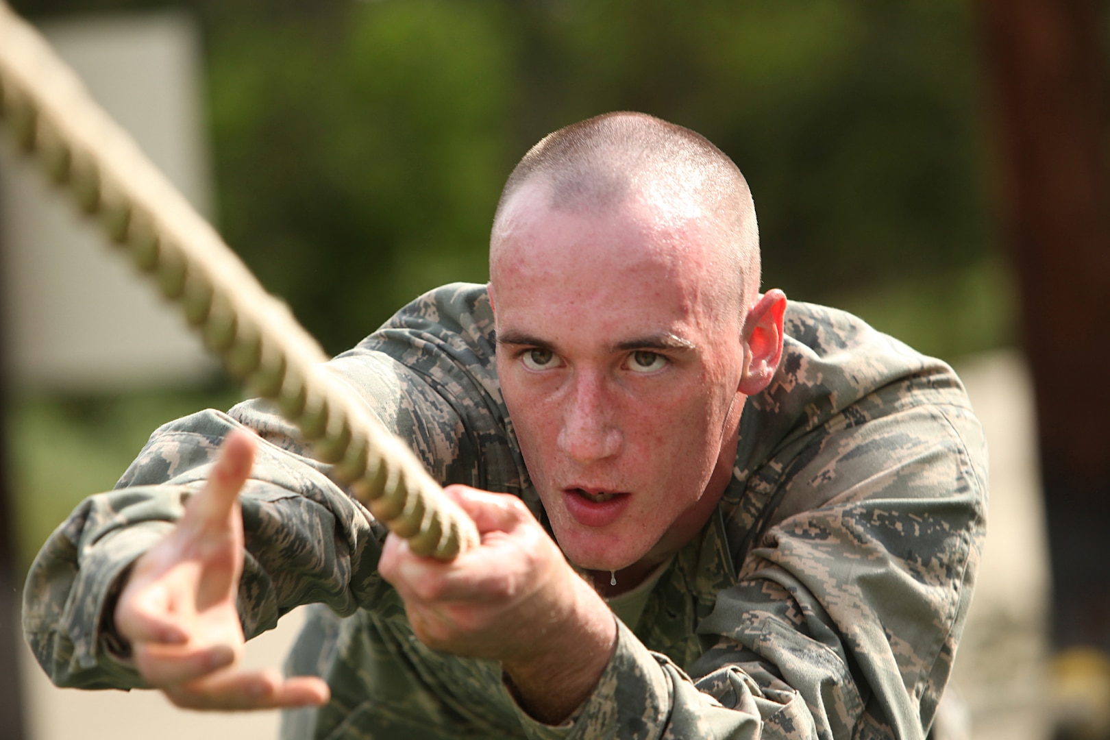 An Air Force Basic Military Training trainee completes an obstacle June 30. The BMT obstacle course tests a trainee's strength, endurance, and will power. (U.S. Air Force photo/Robbin Cresswell)