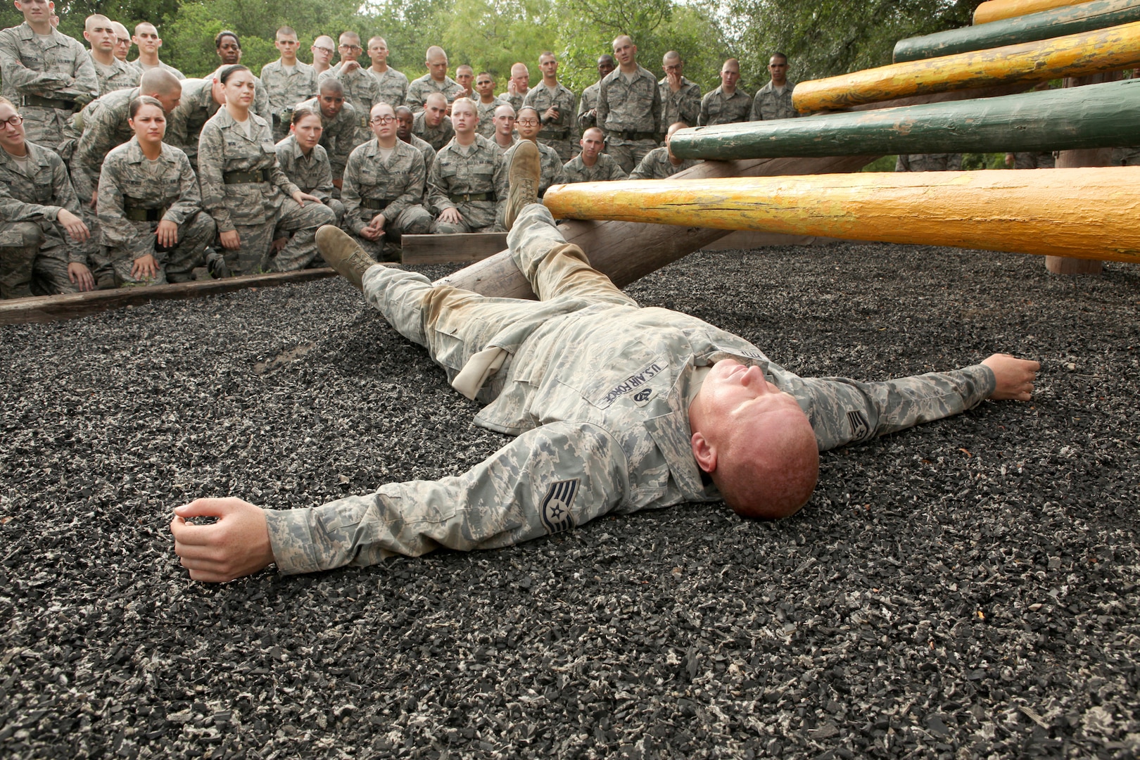 Staff Sgt. Robert Fitte, 319th Training Squadron, demonstrates how to begin an obstacle June 30. Before attempting the obstacle course, Air Force Basic Military Training trainees are briefed on proper technique and safety. (U.S. Air Force photo/Robbin Cresswell)