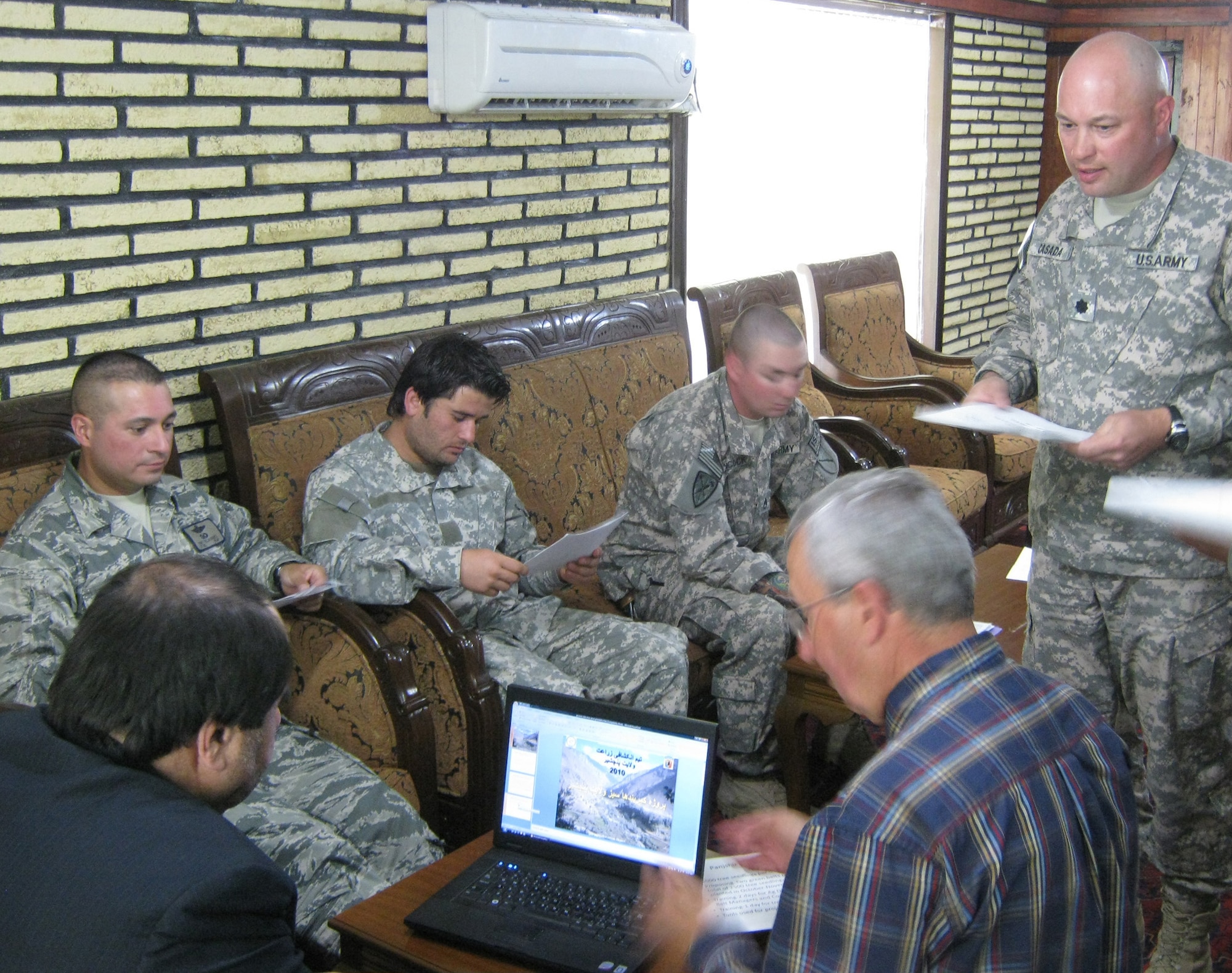 Panjshir Gov. Keramuddin Keram (left) listens to a presentation about the Panjshir Valley Green Belts Project from U.S. Army Lt. Col. Jeffrey Casada (right), Kentucky National Guard Agri-Business Development Team leader with Provincial Reconstruction Team Panjshir and London, Ky., native, while Jim Hoffman, U.S. Department of Agriculture advisor to PRT Panjshir and Boise, Idaho, native, runs the computer slide show. The July 1 presentation proposed a project that could bring 35,000 new trees into the province by the end of the year. (Photo by U.S. Air Force 2nd Lt. Jason Smith, PRT Panjshir Public Affairs)