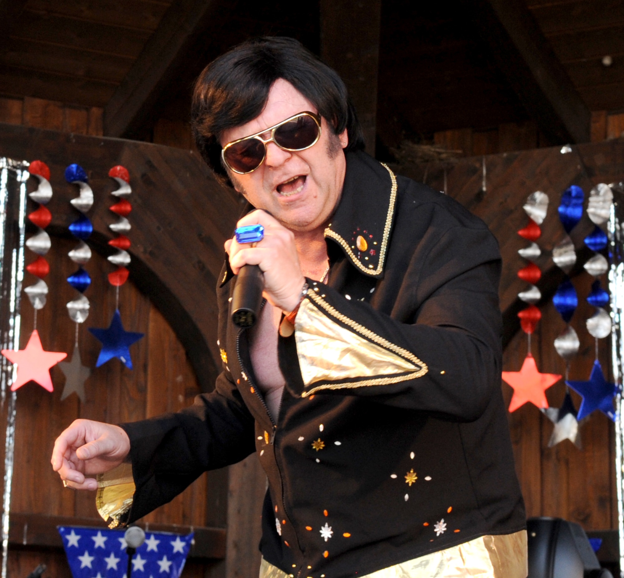 SPANGDAHLEM AIR BASE, Germany – Walter Klein, furniture moving office manager, impersonates Elvis Presleye and sings “If I can dream” during Super Saber Appreciation Day July 4. In addition to live bands, the event included various activity booths, free food, a pet show and fireworks. (U.S. Air Force photo/Airman 1st Class Nick Wilson)