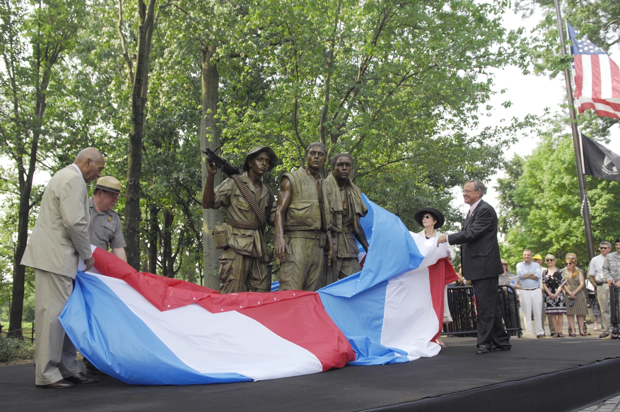 Retired Army Brig. Gen. George Price (from left); John Piltzecker, National Mall and Memorial Parks superintendent; Lindy Hart, widow of sculptor Frederick Hart; and Jan Scruggs, Vietnam Veterans Memorial Fund founder and president, unveil the Three Servicemen Statue July 8, 2010, during a rededication ceremony at the National Mall in Washington, D.C.  The statue, which originally was unveiled in 1984, underwent six weeks of restoration to repair damage and restore the original patina. (Defense Department photo/Army Sgt. 1st Class Michael J. Carden)  