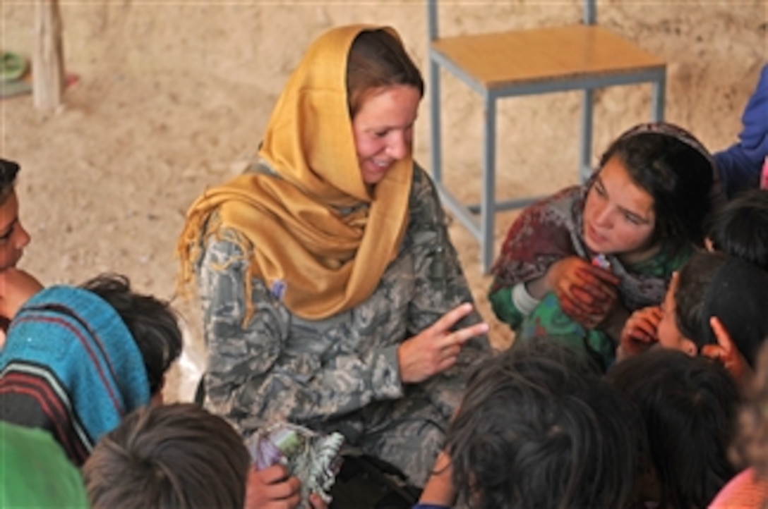 U.S. Air Force 1st Lt. Georganne Hassell, information operations officer of Provincial Reconstruction Team Zabul, teaches Afghan girls to count at the Zarghona Girls' School in Qalat City, Afghanistan, on July 8, 2010.  Members of the Provincial Reconstruction Team visited the school and distributed new head scarves as part of an ongoing humanitarian assistance mission.  