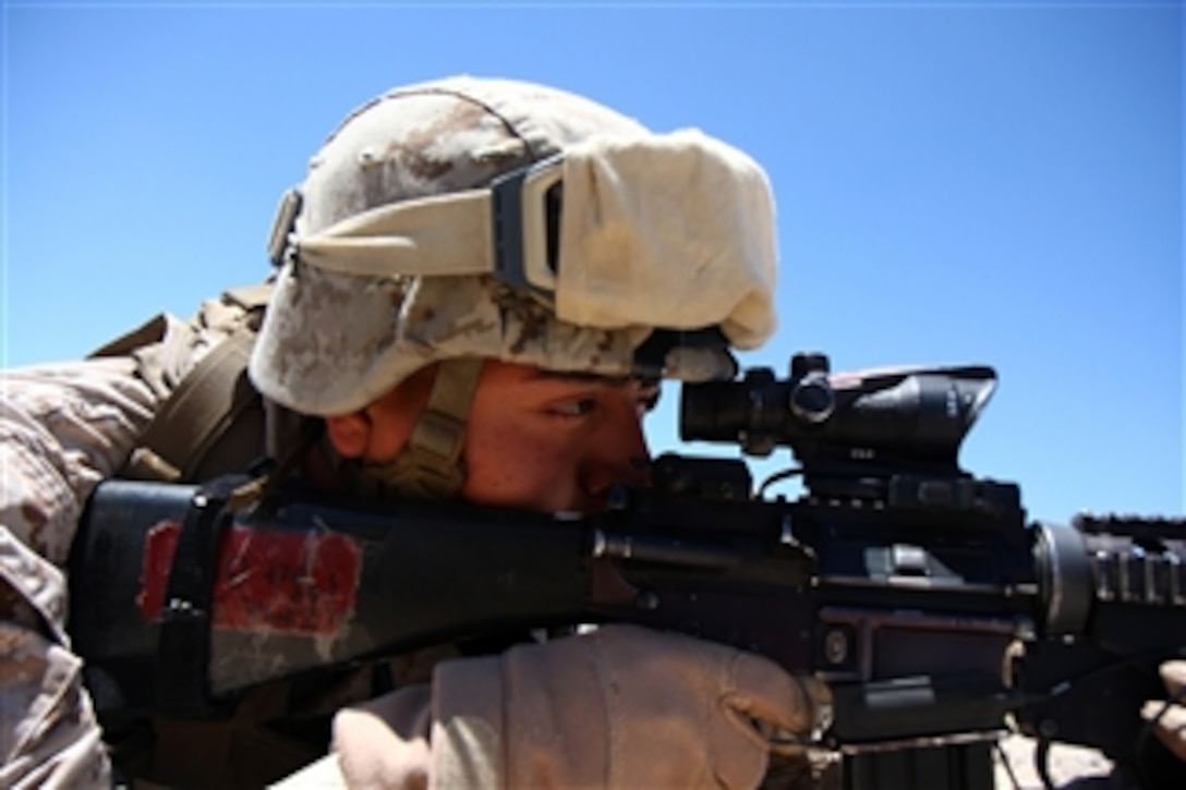 U.S. Marine Corps Lance Cpl. Josue Barron, with 1st Platoon, Lima Company, 3rd Battalion, 5th Marine Regiment, sights his target through an Advanced Combat Optical Gun sight scope at range 107 at Marine Corps Base Twentynine Palms, Calif., during training exercise Enhanced Mojave Viper on July 7, 2010.  