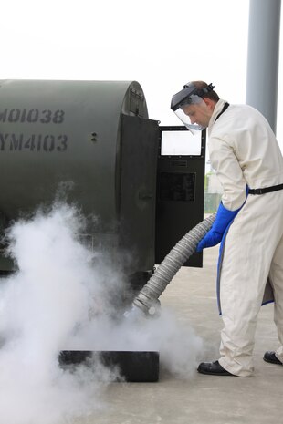 Petty Officer 2nd Class Thomas Armstrong, Station Cryogenics Division technician, purges a cryogenic hose over a liquid oxygen pan at the Navy Cryogenics Division building here July 9. The process of purging clears the hose of excess oxygen or nitrogen particles.
