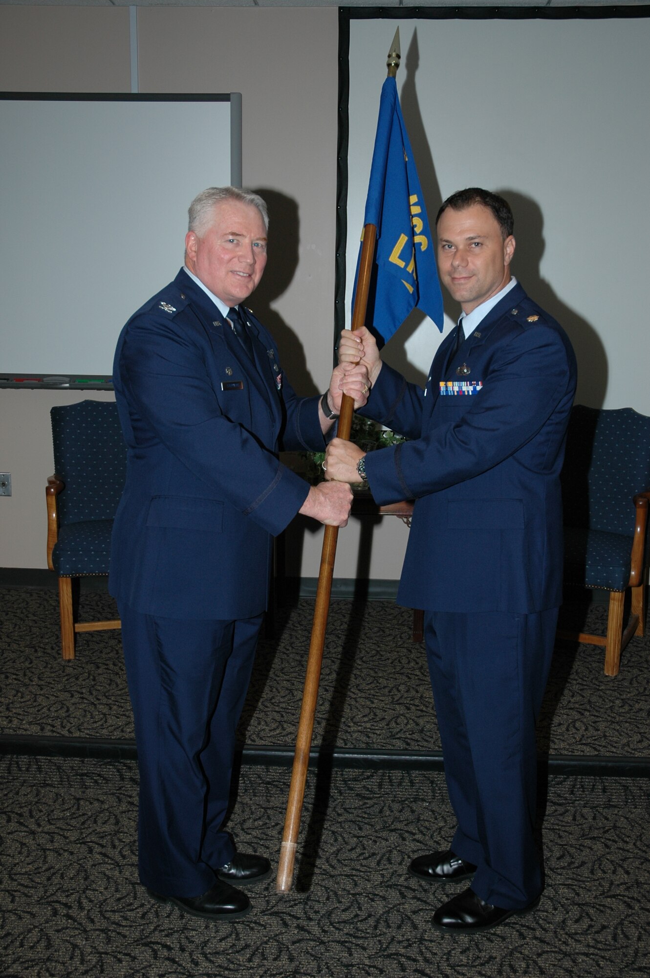 Major Robert M. Degregorio (right) takes the guideon from Colonel William D. Stephens (left), commander of the 315th Mission Support Group, during his assumption of command ceremony here at Charleston Air Force Base, S.C. The 315th Airlift Wing congratulates Major Degregorio  as he assumes command of the 315th Logistics Readiness Flight. 
