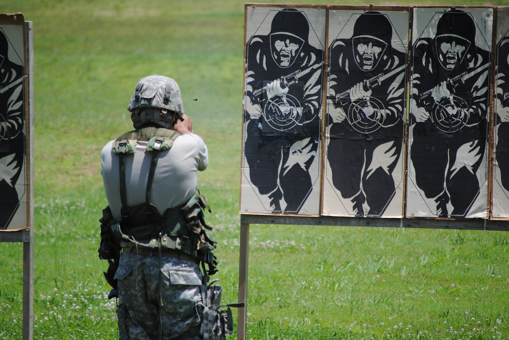 A competitor in the 2010 Tennessee National Guard shooting competition takes a standing firing position and fires an M-9 pistol at his target.