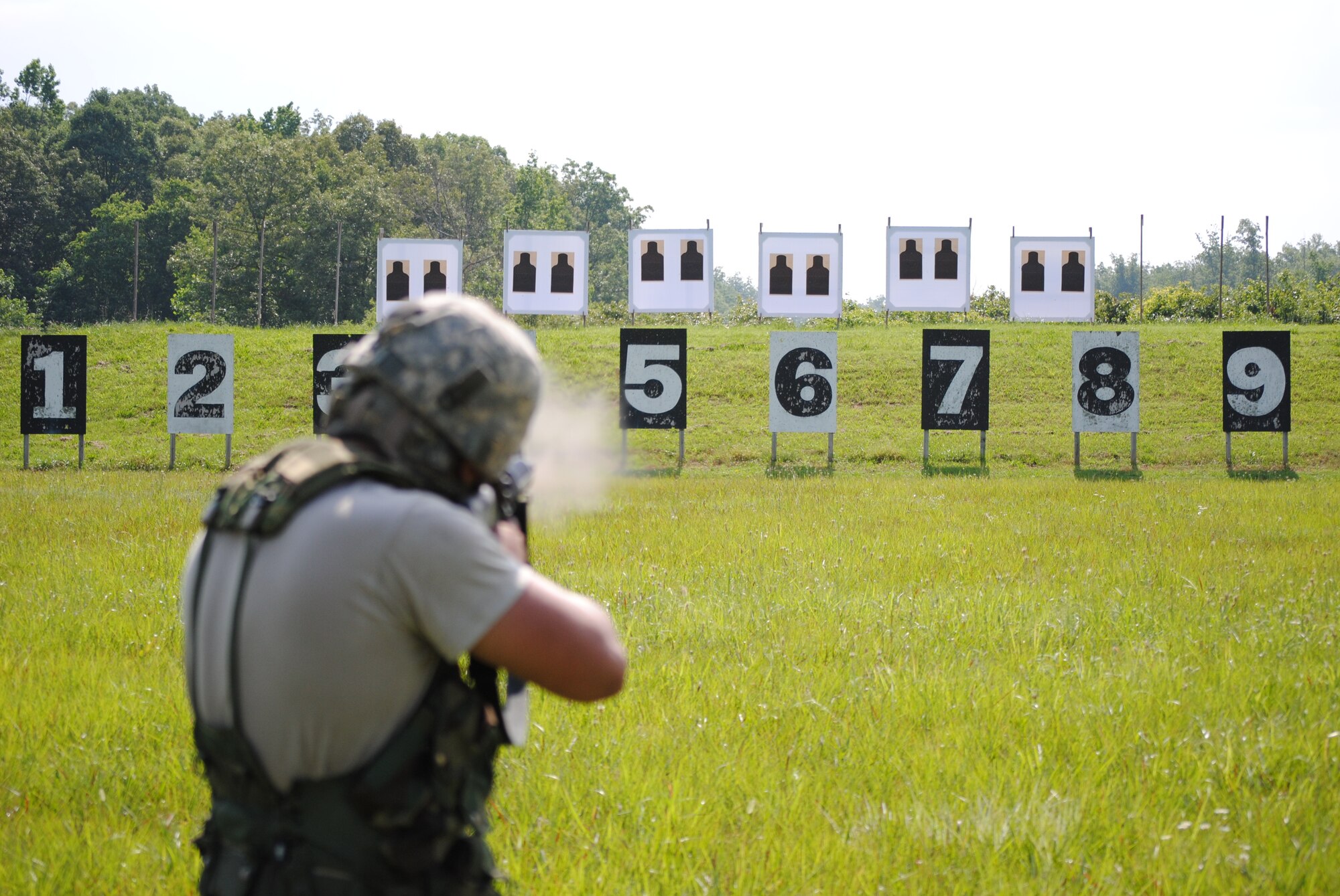 A competitor in the 2010 Tennessee National Guard shooting competition takes a standing firing position and fires on his target.