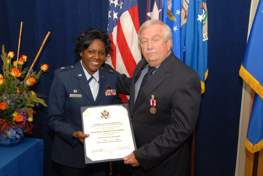 Retired Senior Master Sergeant Curtis Wagner recieves his certificate of retirement from Lt. Colonel Goodson during his retirement ceremony.