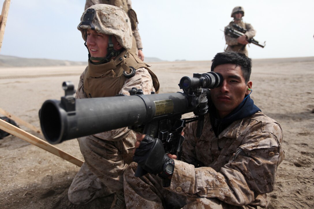 Marines with Special Purpose Marine Air-Ground Task Force 24 show Peruvian Marines how to fire a shoulder-launched multipurpose assault weapon in Salinas, Peru, July 10. The U.S. Marines were embarked aboard transport dock ship USS New Orleans (LPD 18) in support of Partnership of the Americas/Southern Exchange, a combined amphibious exercise with maritime forces from Argentina, Mexico, Peru, Brazil, Uruguay and Colombia.