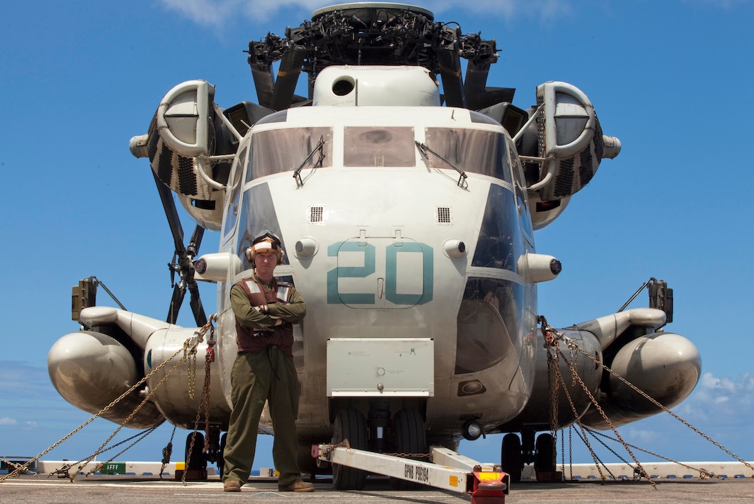 Cpl. James J. Job, a CH-53D Sea Stallion helicopter mechanic with Marine Heavy Helicopter Squadron 463's flight line division, stands in front of one of the countless CH-53Ds he works on daily. The meritoriously-promoted corporal performs daily and turn-around inspections on the squadron's helicopters, conducting a complete overlook of the plane's major components and integrity. Inspections typically take between two and four hours, Job said.