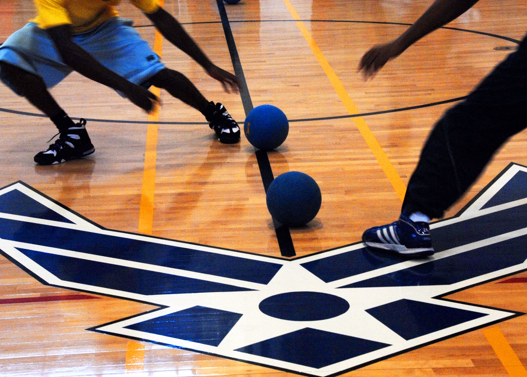Team members race to the center to grab the dodgeballs starting the game during a tournament held at the fitness center July 9.  Air Force Research Lab team members took first place in the tournament.  The winning team was Joe Czabaranek, Ryan Snider, Brian Nagle, Jordan Harrison and Tim Ager.  U.S. Air Force photo/Samuel King Jr.
