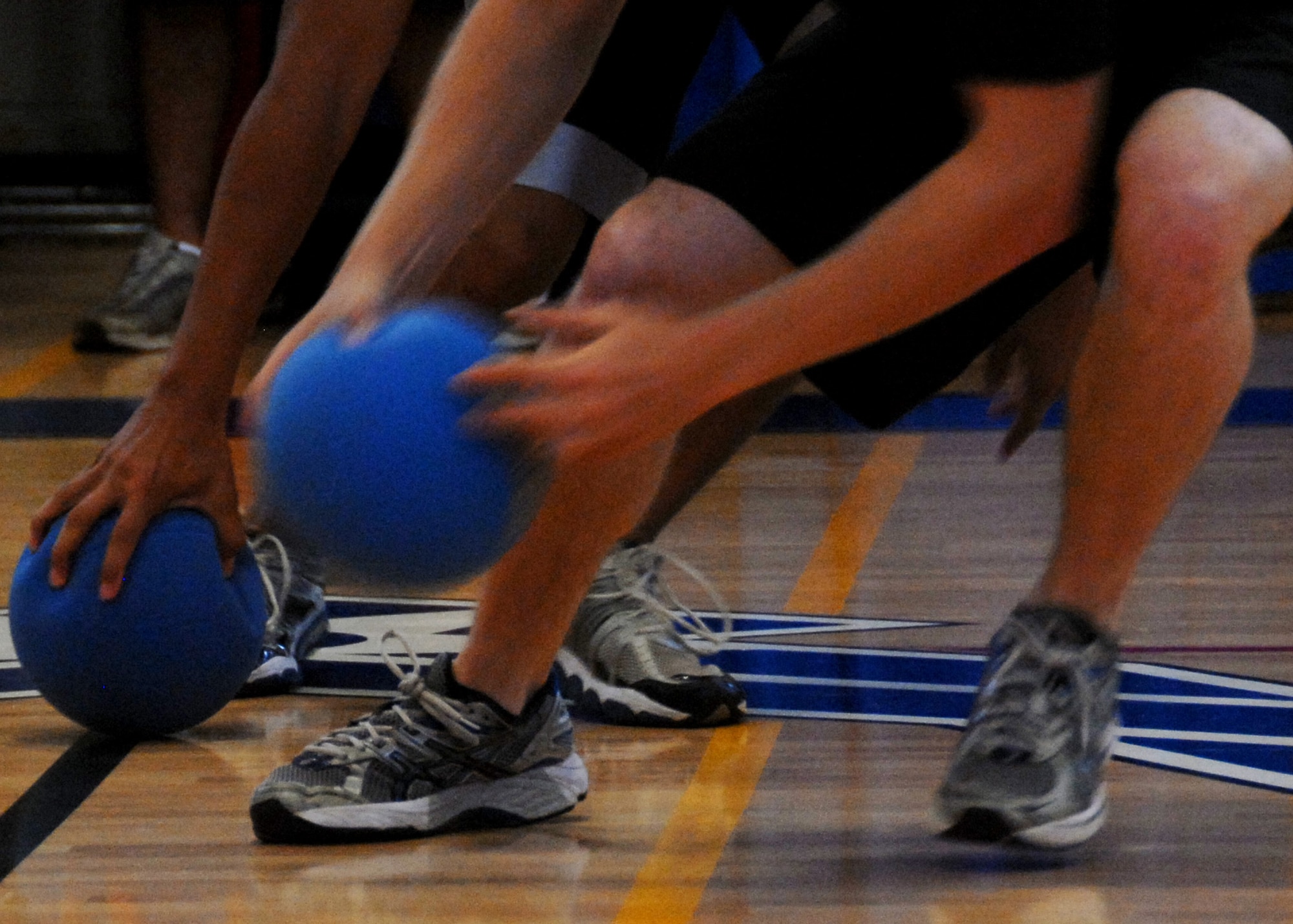 Team members race to the center to grab the dodgeballs starting the game during a tournament held at the fitness center July 9.  Air Force Research Lab team members took first place in the tournament.  The winning team was Joe Czabaranek, Ryan Snider, Brian Nagle, Jordan Harrison and Tim Ager.  U.S. Air Force photo/Samuel King Jr.
