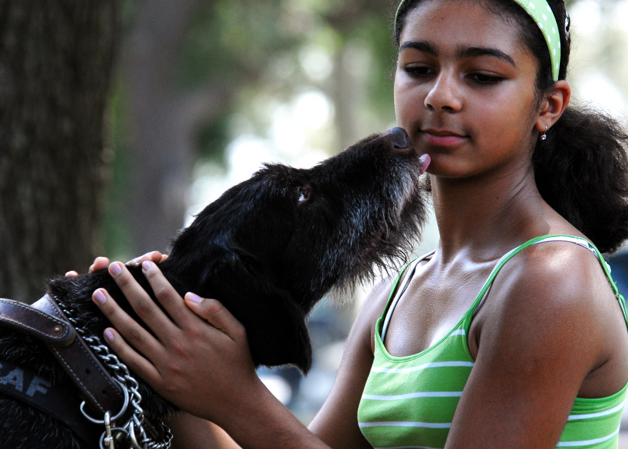 Laura Martinez gets a kiss from Kanjer, a wire-haired pointer with the 96th Security Forces Squadron, during the All-American Heroes picnic July 9 at Eglin Air Force Base, Fla.  (U.S. Air Force photo/Samuel King Jr.)