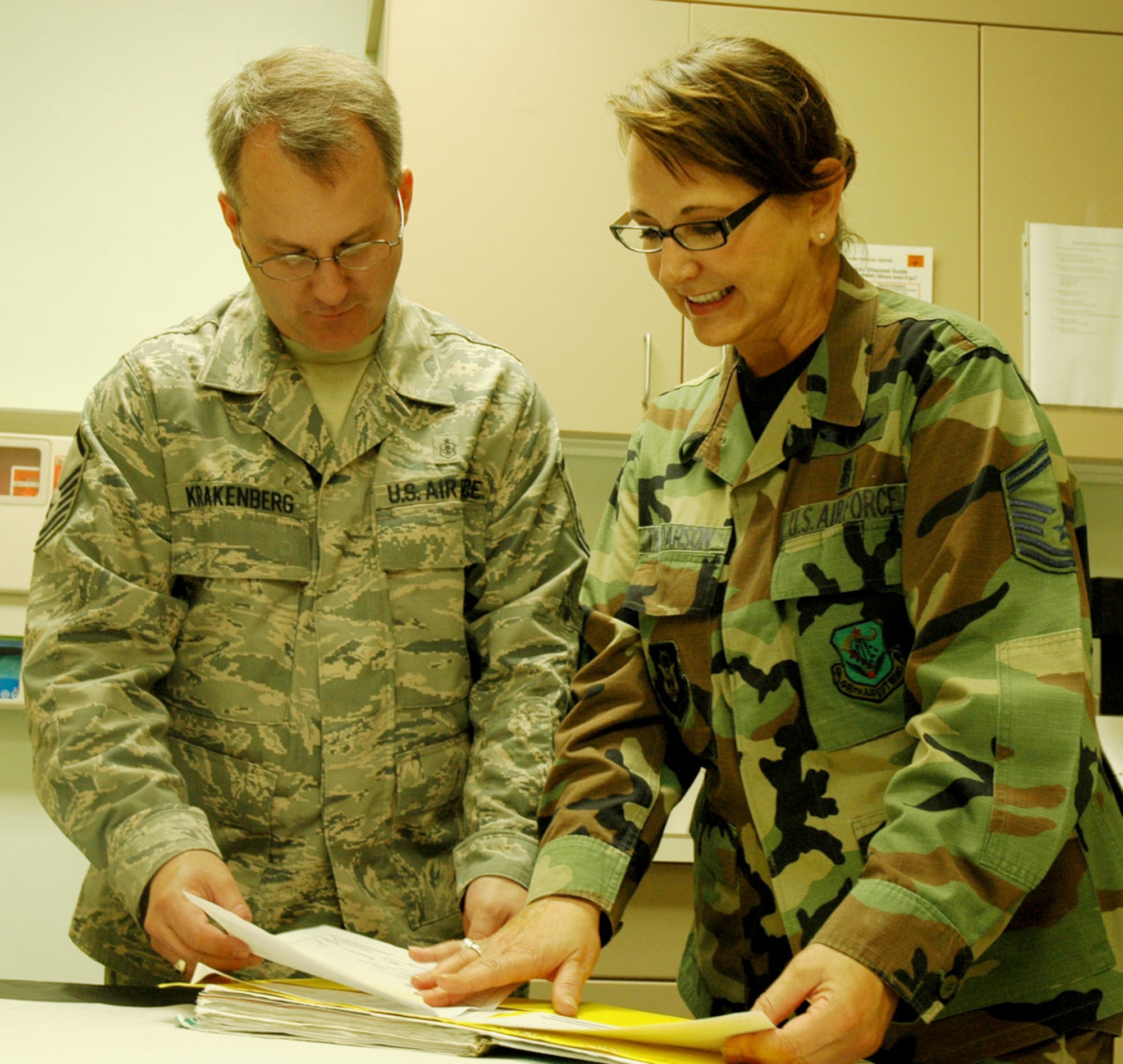 JOINT BASE LEWIS MCCHORD, Wash. - Senior Master Sgt. Dorothy "Dot" Thordarson, 446th Aerospace Medicine Squadron, discusses a medical record with Master Sgt. John Krakenberg, 446th AMDS during a UTA here July 10. Both Reservists were part of a recent annual tour to Rocky Boy Indian Reservation in northeastern Montana. Flash flooding at the reservation led to a state of emergency, and demanded extreme flexibility on the part of the medical professionals. (U.S. Air Force photo/Staff Sgt. Grant Saylor)