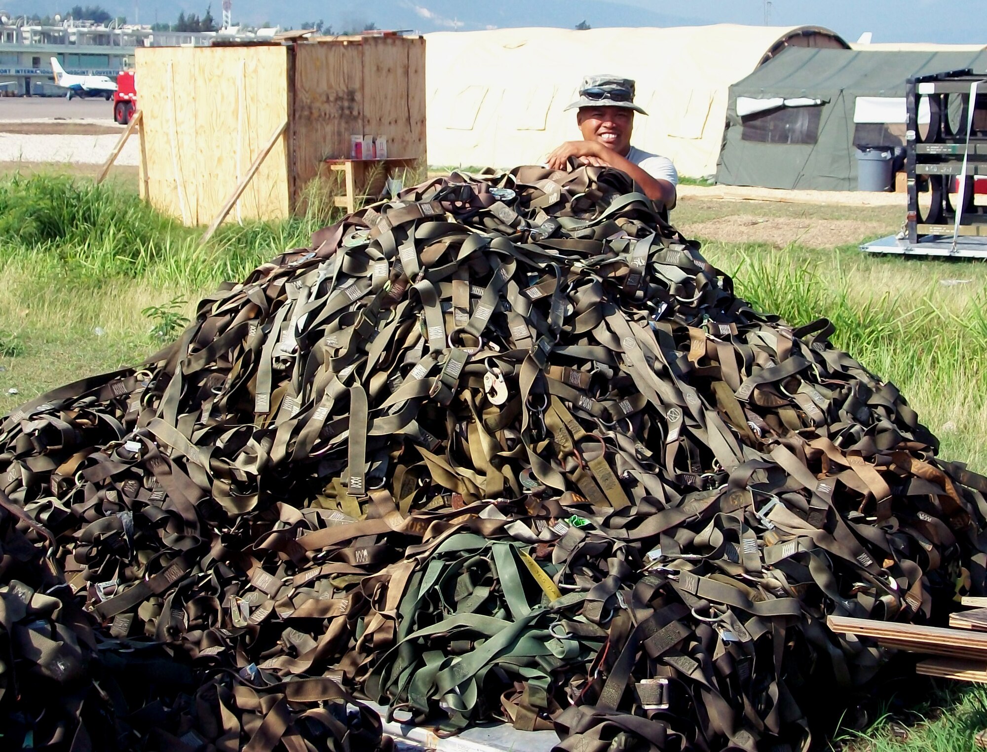 JOINT BASE LEWIS-MCCHORD, Wash. -- Master Sgt. Rodney Fernandez, 86th Aerial Port Squadron's security manager is buried in work.  Sergeant Fernandez stands behind 3,100 pounds of net straps used to secure aircraft cargo.