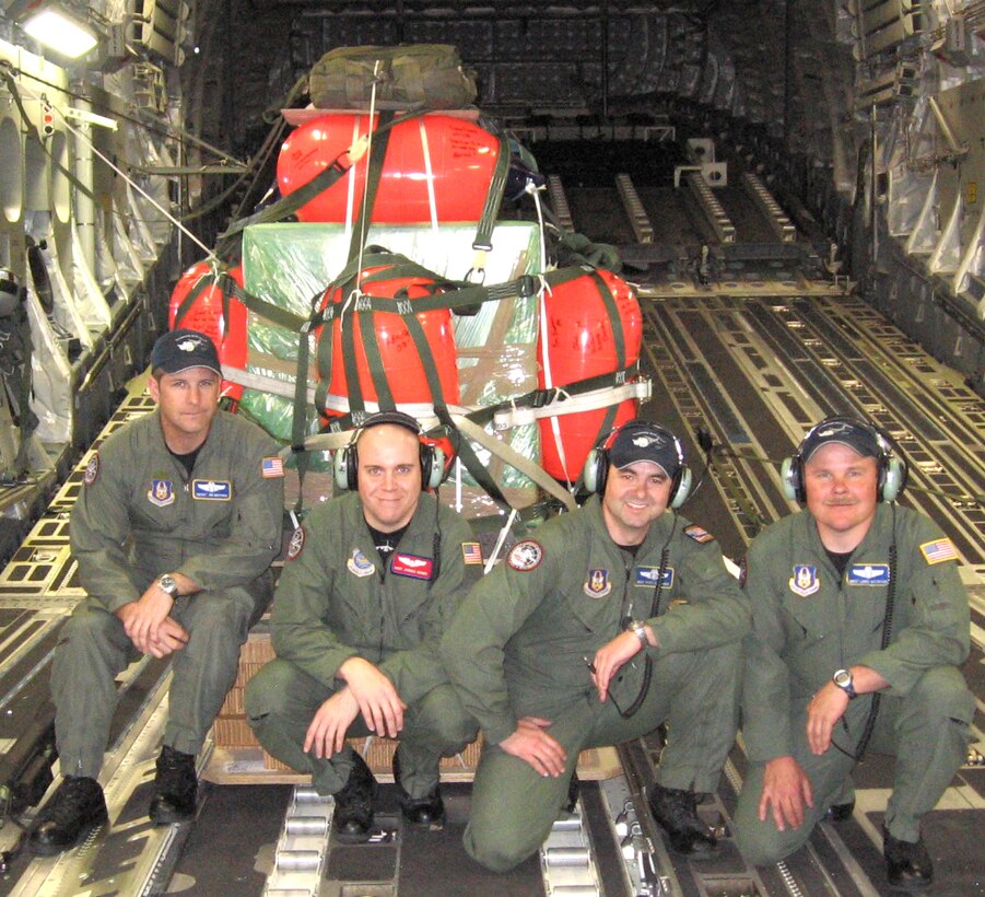 JOINT BASE LEWIS-MCCHORD, Wash. -- The 728th AS was recognized for their excellence in airlift support by winning the 2009 Grover Loening Award. (From left to right) Chief Master Sgt. James Masura, a Wing Stan Eval loadmaster, 446th Operations Group here, Tech. Sgt. Joshua Denny, a loadmaster with the 16th Airlift Squadron, Charleston Air Force Base, S.C., Master Sgt. Scott Dellinger, a loadmaster with the 728th Airlift Squadron here, and Senior Master Sgt. Lance Gustafson, a loadmaster assigned to the 313th Airlift Squadron here, on an airdrop mission.  