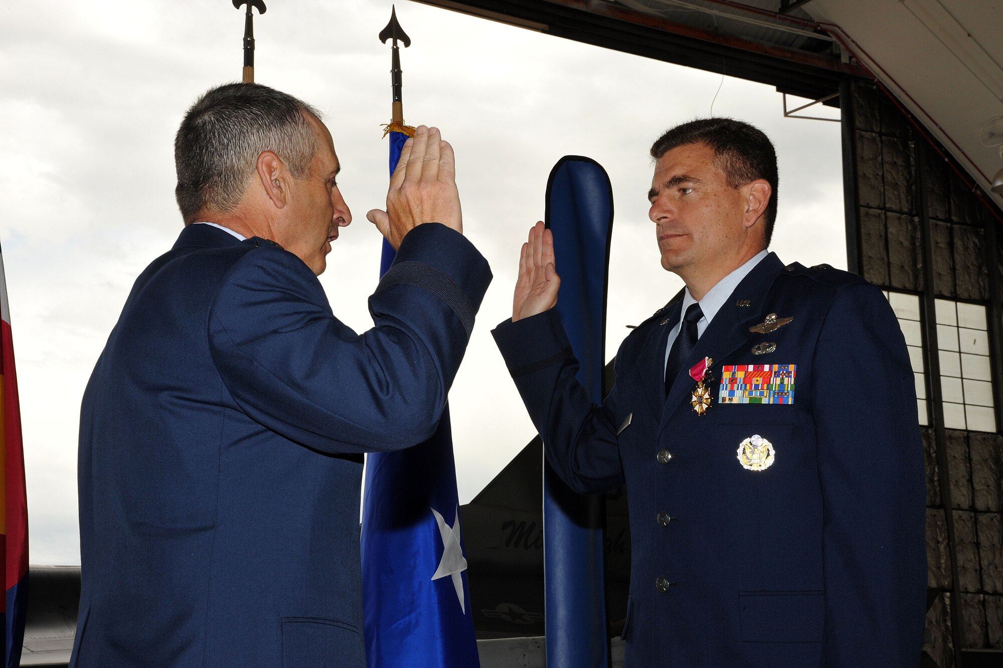 The Adjutant General of Colorado Maj. Gen. H. Michael Edwards administers the Oath of Office to Brig. Gen. Michael Loh July 10.  Loh will be relocating to Washington D.C. to serve as the Air National Guard advisor to the Air Force Chief of Staff.  He is  the former 140th Operation Group Commander, 140th Wing, Colorado Air National Guard, Buckley Air Force Base, Colo.  Loh has been a pilot for the 120th Fighter Squadron at Buckley AFB since 1991.  U.S. Air Force Photo By: Tech. Sgt. Wolfram M. Stumpf (Released)  
