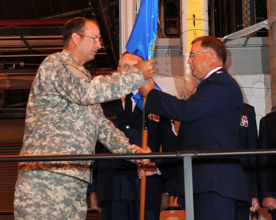 Major General Brian Tarbet, Adjutant General for the Utah National Guard, passes the flag to Colonel Wayne Lee, who assumed command as the Assistant Adjutant General of the Utah Air National Guard in a ceremony on July 10, 2010, at the 151st Air Refueling Wing, Salt Lake City. (U.S. Air Force photo by MSgt Gary J. Rihn) 	