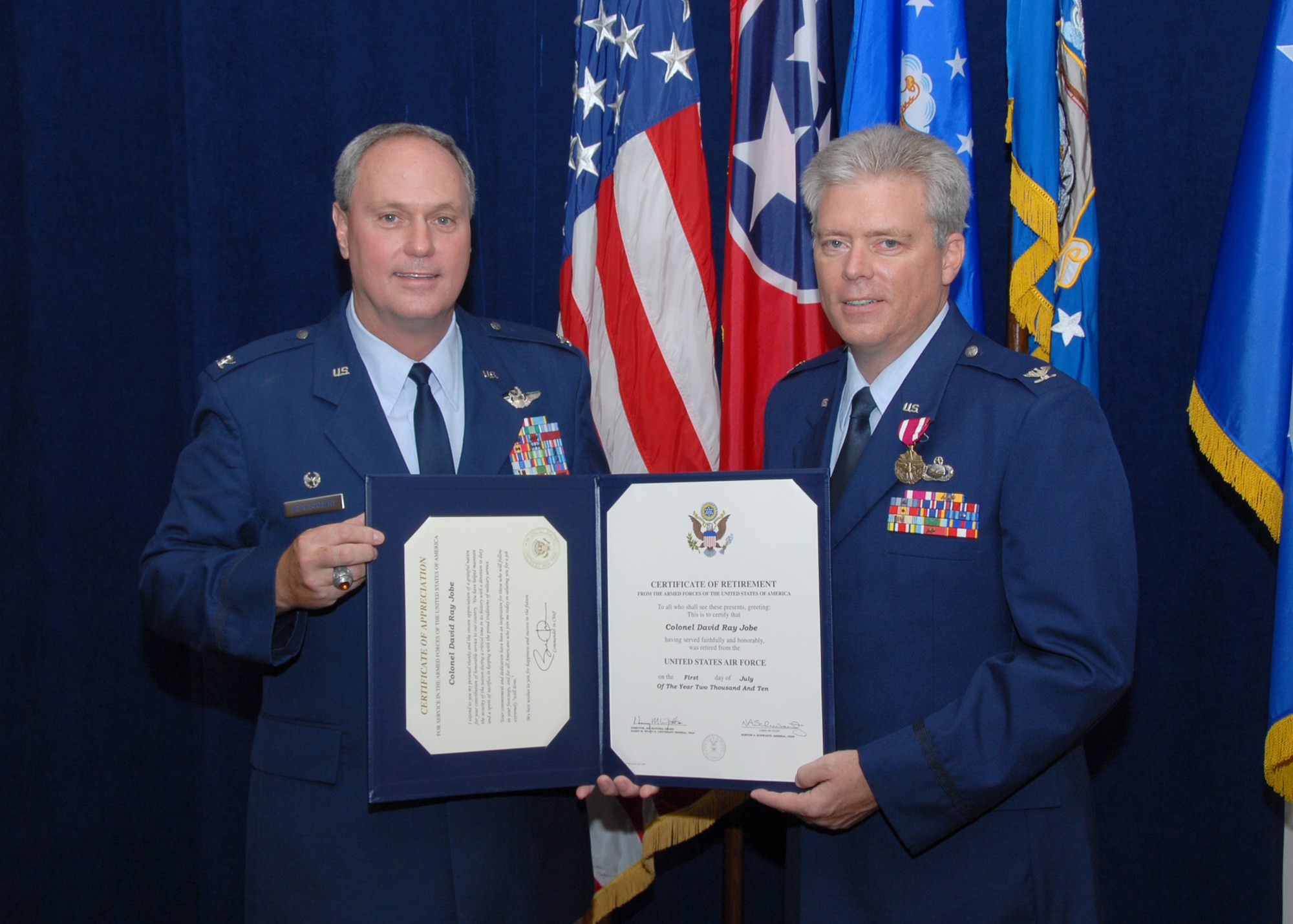 Colonel Harry Montgomery presents Colonel David Jobe with a certificate of retirement at Col Jobe's retirement ceremony held on July 10th, 2010.