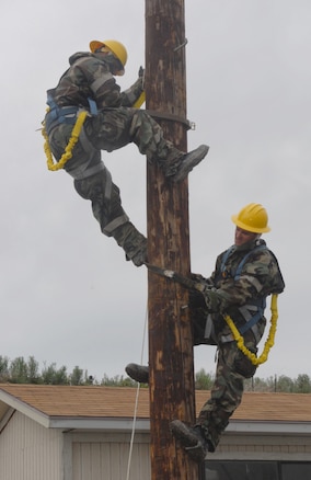 Members of the 130th EIS climb a telephone pole to set up an antenna during the unit's ORE in preparation for their upcoming UCI in May.  (U.S. Air Force photo by Airman 1st Class Emily Hoferitza)