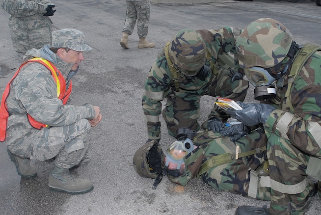 Master Sergeant Douglas Amadio coaches members of the 130th EIS through a self aid and buddy care scenario during the unit's ORE in June. (U.S. Air Force photo by Airman 1st Class Emily Hoferitza)