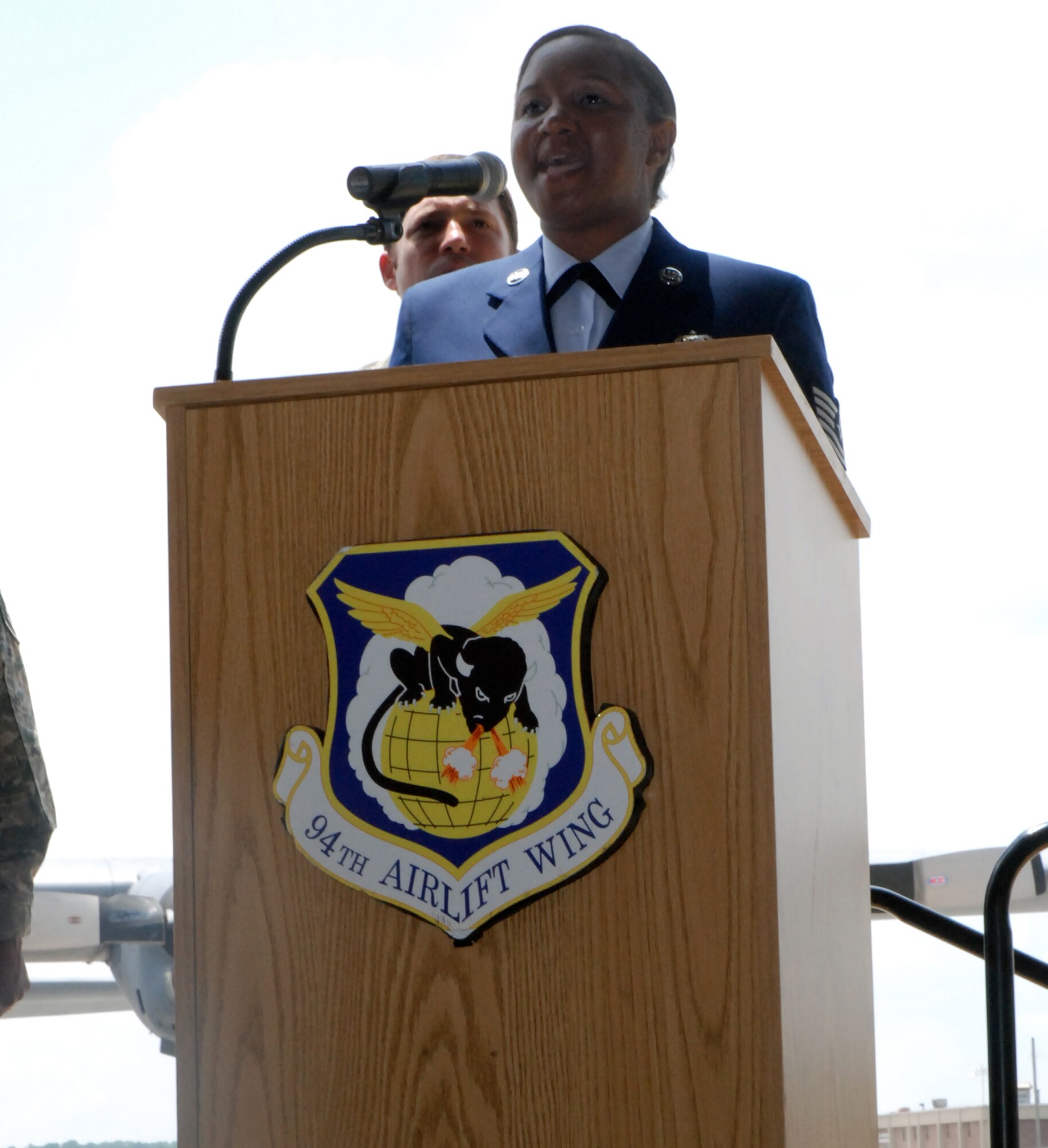 Audrey Q. Latson, 94th Airlift Wing Mission Support Squadron, sings the National Anthem at Col. Webb's Assumption of Command ceremony (U.S. Air Force photo by Airman 1st Class Danielle Campbell)