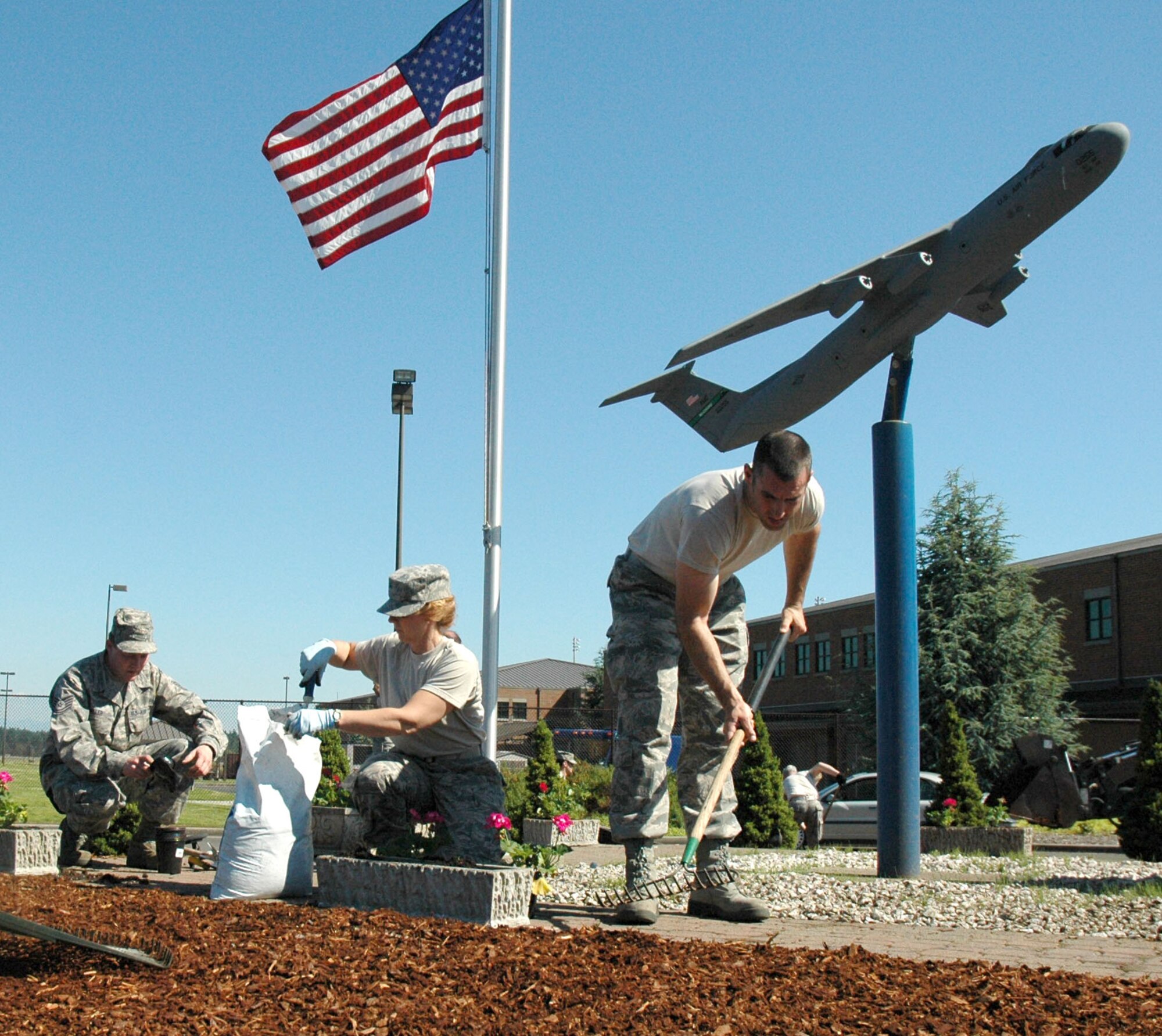 JOINT BASE LEWIS-MCCHORD, Wash. - Reservists with the 446th Aircraft Maintenance Squadron took their time sprucing up the McChord 13 memorial site here, July 10. The Reservists took part in the beautification effort to honor the 13 Airmen who died after their C-141 aircraft crashed during a routine refueling flight over Montana, Nov. 30, 1992. (U.S. Air Force Photo/Staff Sgt. Nicole Celestine)