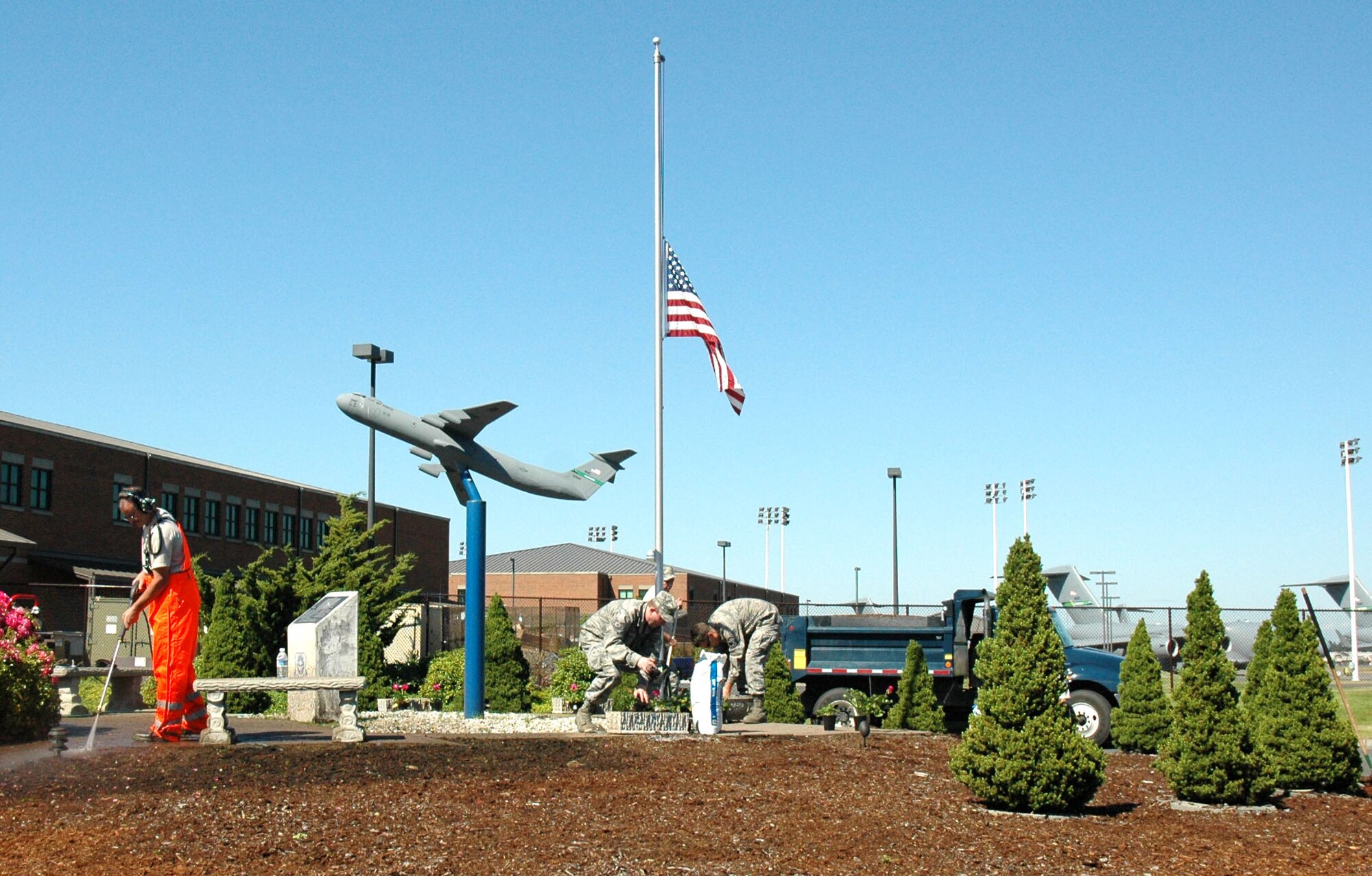 JOINT BASE LEWIS-MCCHORD, Wash. - Reservists with the 446th Aircraft Maintenance Squadron took their time sprucing up the McChord 13 memorial site here, July 10. The Reservists took part in the beautification effort to honor the 13 Airmen who died after their C-141 aircraft crashed during a routine refueling flight over Montana, Nov. 30, 1992. (U.S. Air Force Photo/Staff Sgt. Nicole Celestine)