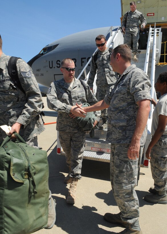 Capt. Keith McCray, 459th Maintenance Group, welcomes Airmen from the 459th Air Refueling Wing after returning home from a deployment to Southwest Asia, here July 3. (U.S. Air Force photo/Staff Sgt. Melissa Stonecipher)