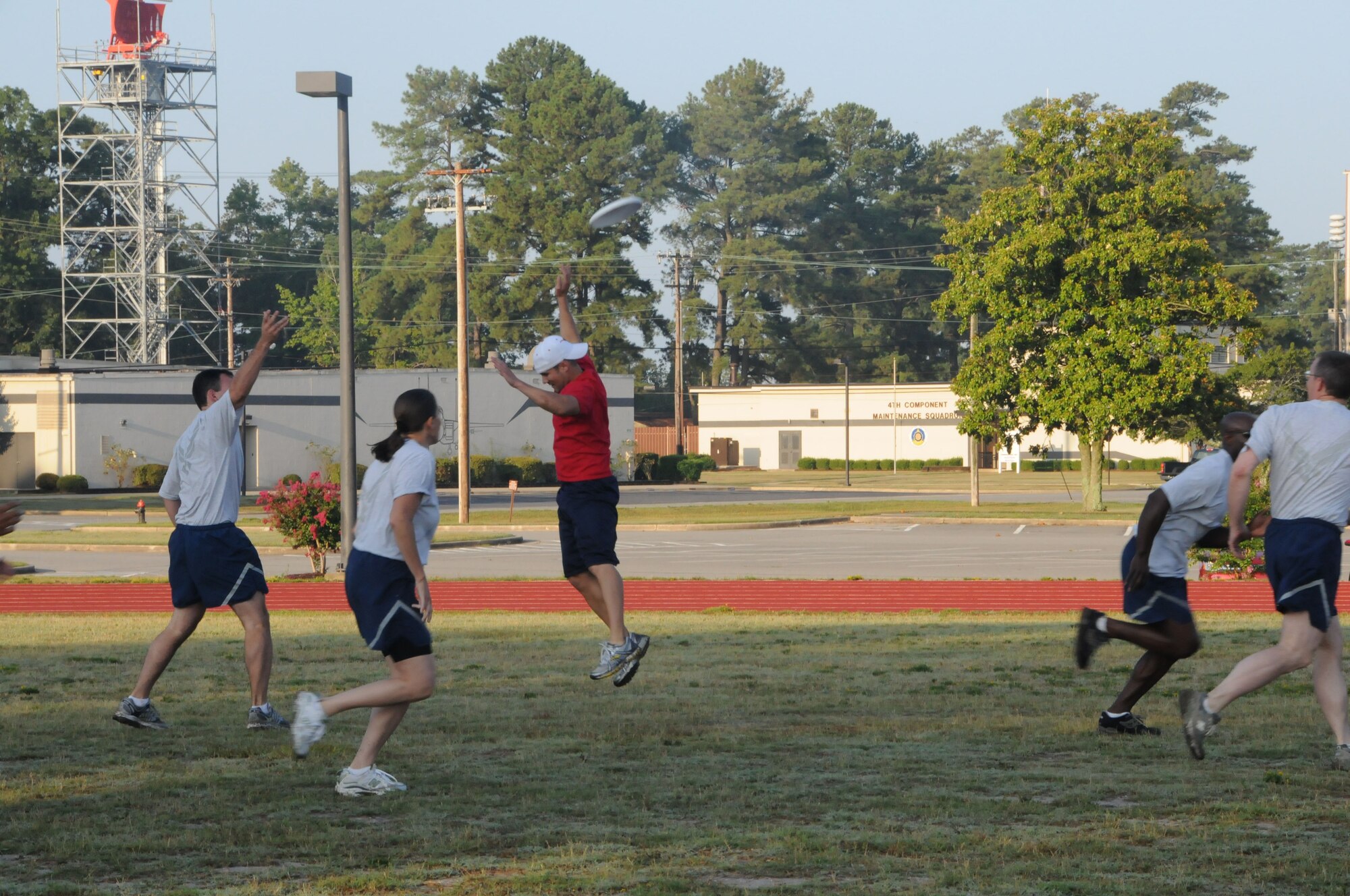 Staff Sgt. Sean Gilson, 911th boom, goes for the block as Lt. Col. Gary Wilson, Wing Inspector General, passes long during the wing staff ultimate frisbee game during July drill. (USAF photo by 916ARW/PA)