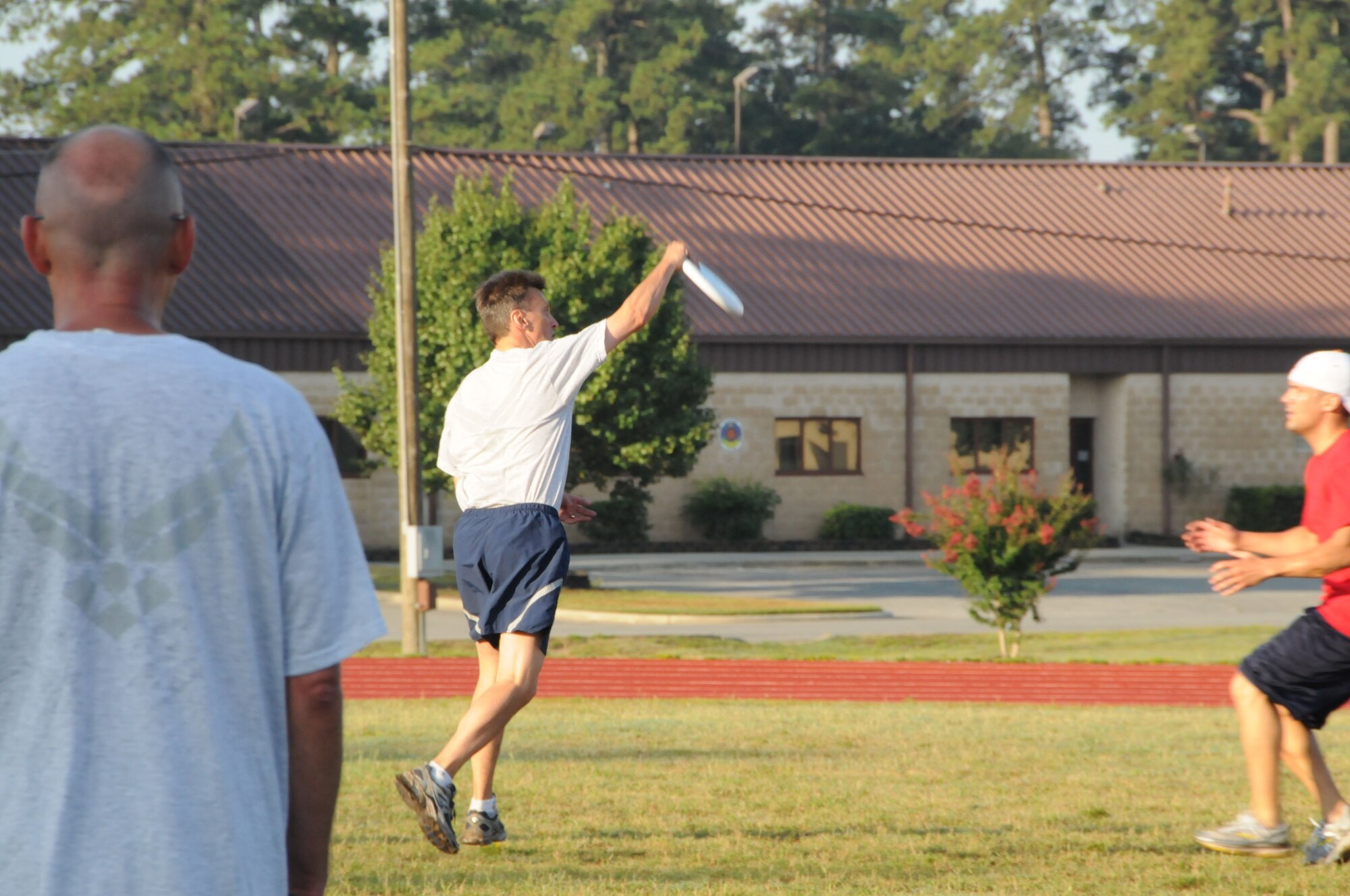 Col. Randy Ogden, 916th ARW commander, catches the frisbee as Staff Sgt. Sean Gilson, 911th boom, approaches to defend. (USAF photo by 916ARW/PA)