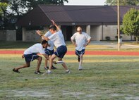 Capt. Stephen Stokes, Wing Equal Opportunity, fakes the frisbee under the legs of Lt. Col. Gary Wilson, Wing Inspector General. Senior Master Sgt. Jeff Williams, 916th Security Forces, look whooped in the background. (USAF photo by 916ARW/PA) 