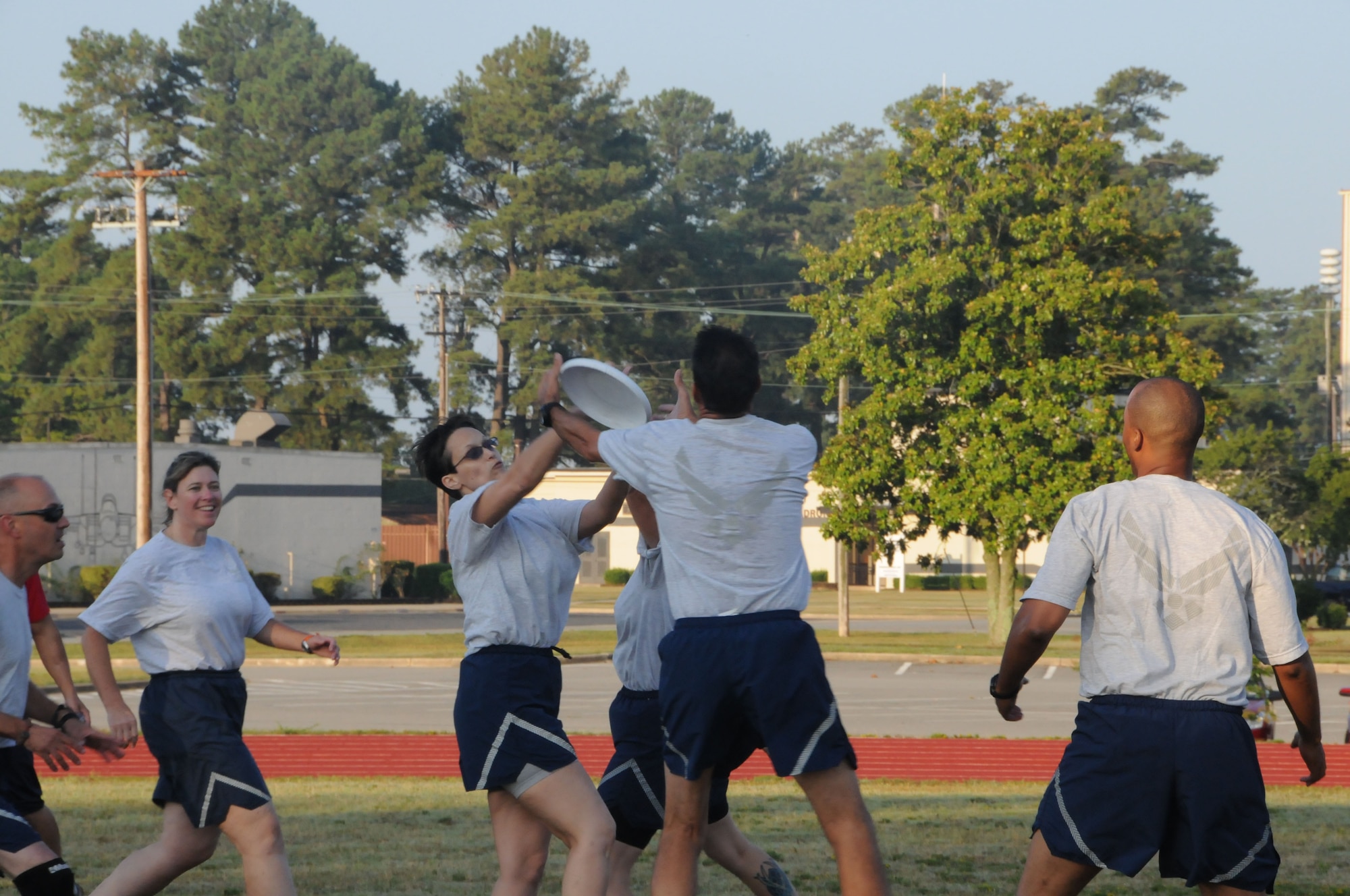Maj. Shelley LeVan, Wing Equal Opportunity, races for the frisbee along with Capt. Stephen Stokes, Wing Equal Opportunity. (916ARW/PA)