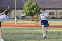 Maj. Shelley LeVan, Equal Opportunity chief, passes the frisbee to Col. Caroline Evernham, Opertions Group commander. 916th Air Refueling Wing staff had their first game on Sunday of the July unit training assembly. Col. Evernham was a spy for the Ops Group. (USAF photo by 916ARW/PA)