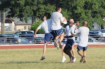 Capt. Barry Crosby, wing executive officer, grabs the frisbee as Col. Randy Ogden, wing commander tries to defend. Command Chief Greg Nelson, Senior Master Sgt. Terry McCabe, Operations Support first sergeant and Staff Sgt. Samaad Bynum, wing historian, race in to help. (USAF photo by 916ARW/PA)