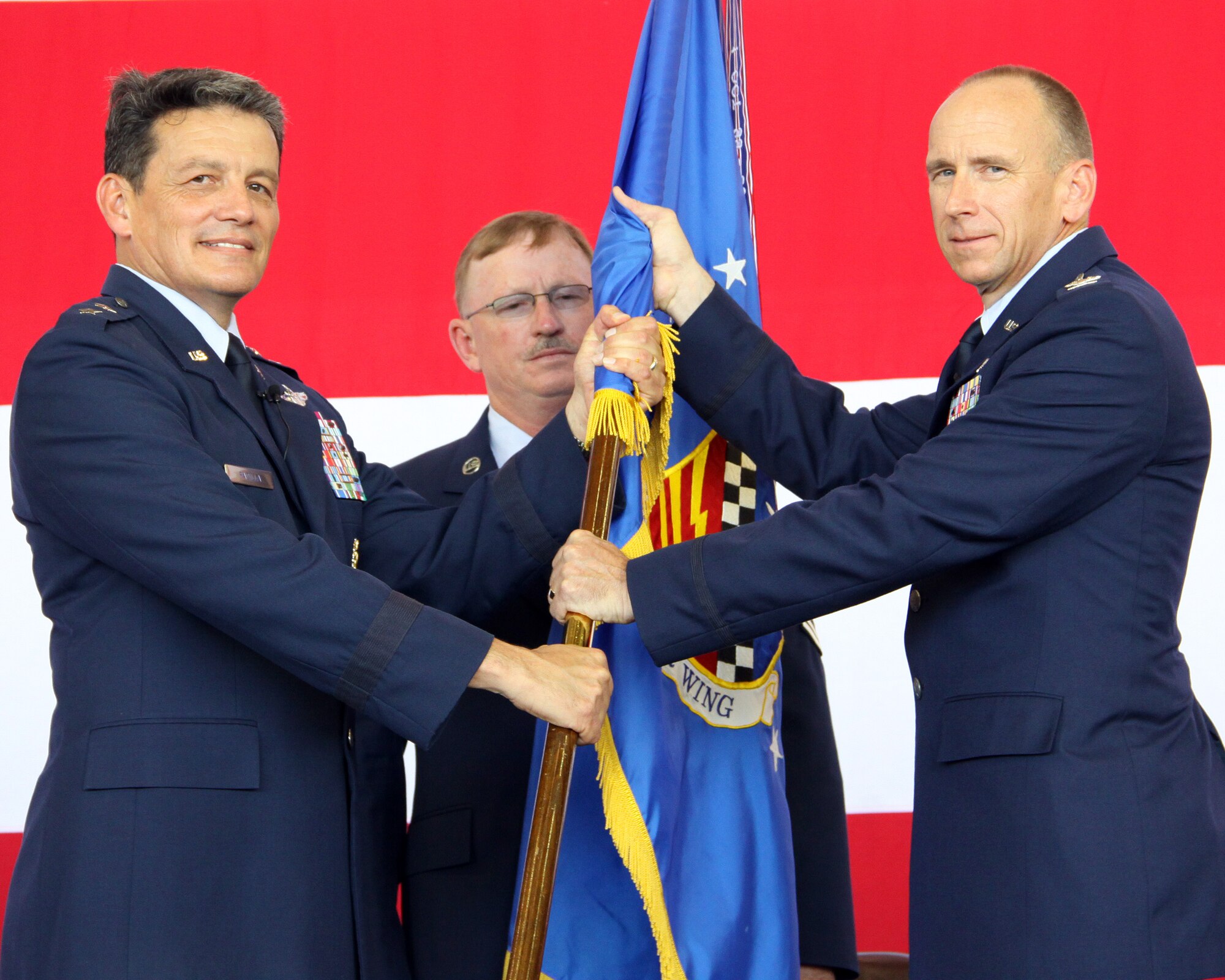 Maj. Gen. Frank J. Padilla (left), Commander, 10th Air Force, Naval Air Station Joint Reserve Base Fort Worth, Texas, transfers the 482nd Fighter Wing flag of command to Col. Donald R. Lindberg. The change of command ceremony took place inside hangar 200 at Homestead Air Reserve Base, Fla., on July 10. (U.S. Air Force photo/Tech. Sgt. Ian Carrier) 