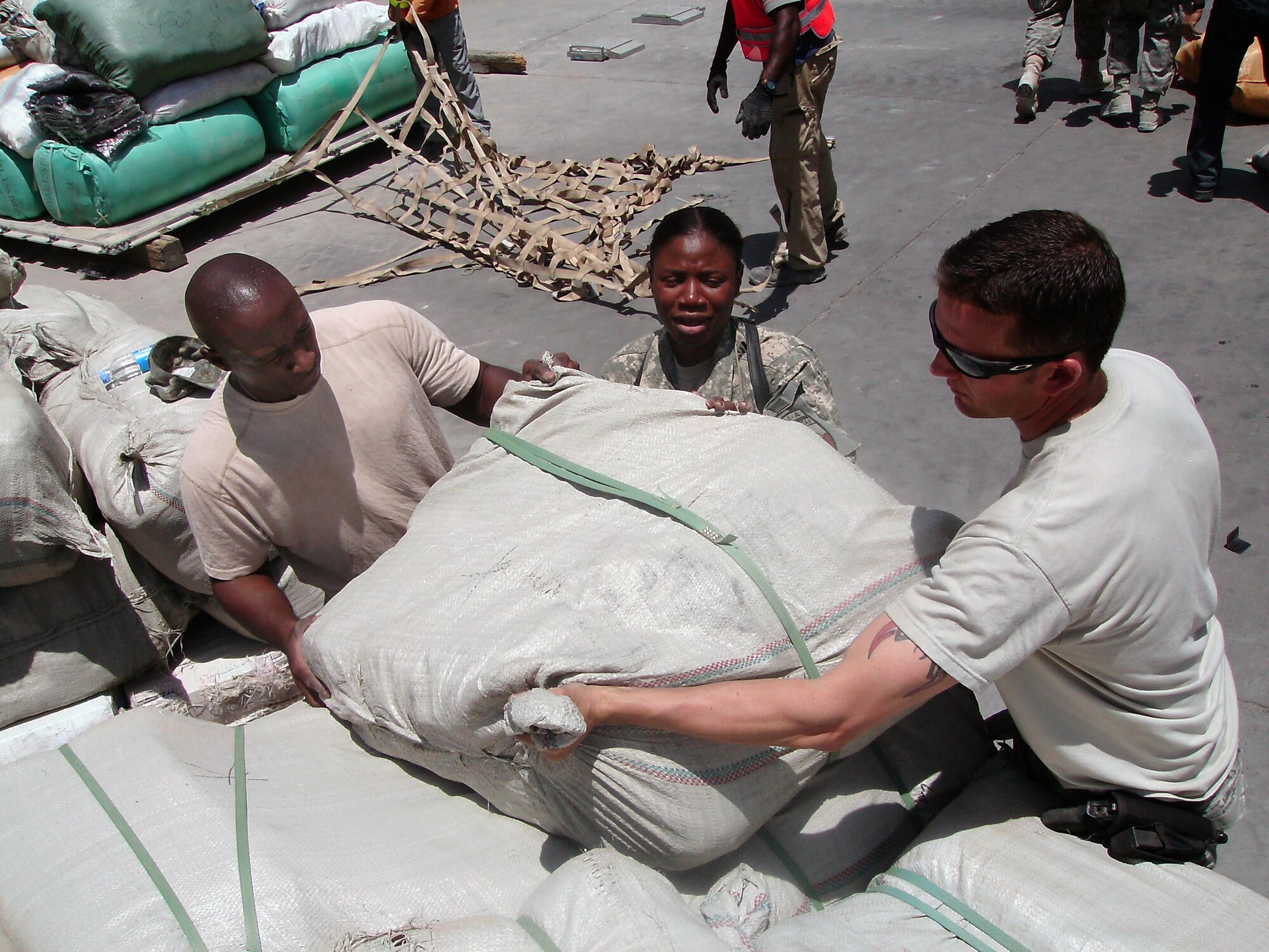 100707-N-6031Q-005 KABUL, Afghanistan --Technical Sergeant Osby Watts, Capt. Anita Boone, and Master Sergeant Michael Parker, from the 438th Air Expeditionary Wing pack nearly 7000 pounds of humanitarian supplies onto pallets for transport from Bagram Air Field to the Afghan Air Force base in Kabul, Afghanistan on July 7, 2010.  (U.S. Navy photo by Mass Communication Specialist 2nd Class David Quillen/ RELEASED).