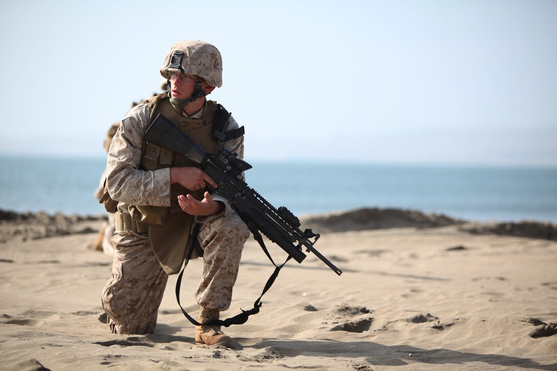 A Marine with Special Purpose Marine Air-Ground Task Force 24 surveys his surroundings during a beach assault with Peruvian Marines in Salinas, Peru, July 11. The U.S. Marines were embarked aboard transport dock ship USS New Orleans (LPD 18) in support of Partnership of the Americas/Southern Exchange, a combined amphibious exercise with maritime forces from Argentina, Mexico, Peru, Brazil, Uruguay and Colombia.