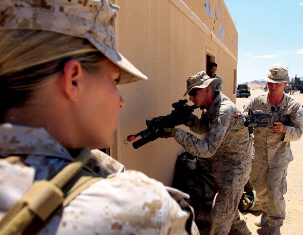 Sgt. Jessica Otto, fire team leader, FET fire team B, and native of Reno, Nev., scans the horizon during a patrolling exercise Monday at the Combat Center. “I volunteered [for the FET] because it was always something I’ve wanted to do,” Otto said. “A female engagement team is the closest thing to combat females can get. I’ve done a lot in the Marine Corps, but this is something that sticks out.”