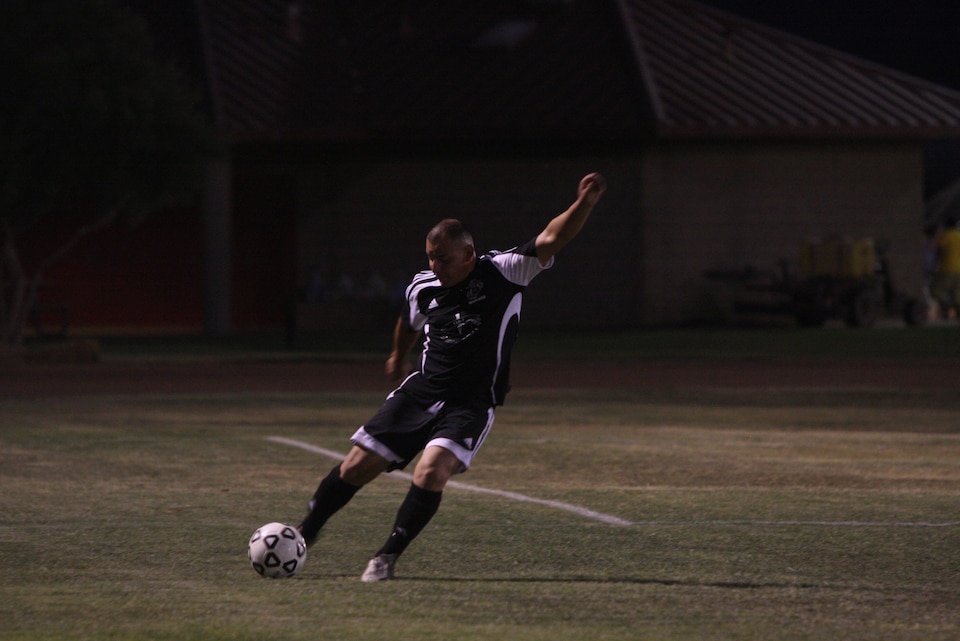 MARINE CORPS AIR GROUND COMBAT CENTER TWENTYNINE PALMS, Calif.--A player from the CLB-7 team kicks the ball up field during the Commanding General's Intramural Soccer League soccer semifinal game against HQBN at Felix Field Monday.