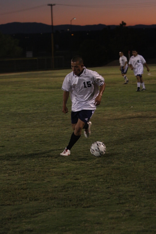 MARINE CORPS AIR GROUND COMBAT CENTER TWENTYNINE PALMS, Calif.--A player from the HQBN team, looks to control the ball during the Commanding General's Intramural Soccer League soccer semifinal game against CLB-7 at Felix Field Monday. (U.S. Marine Corps photo by Pfc. Sarah Anderson)