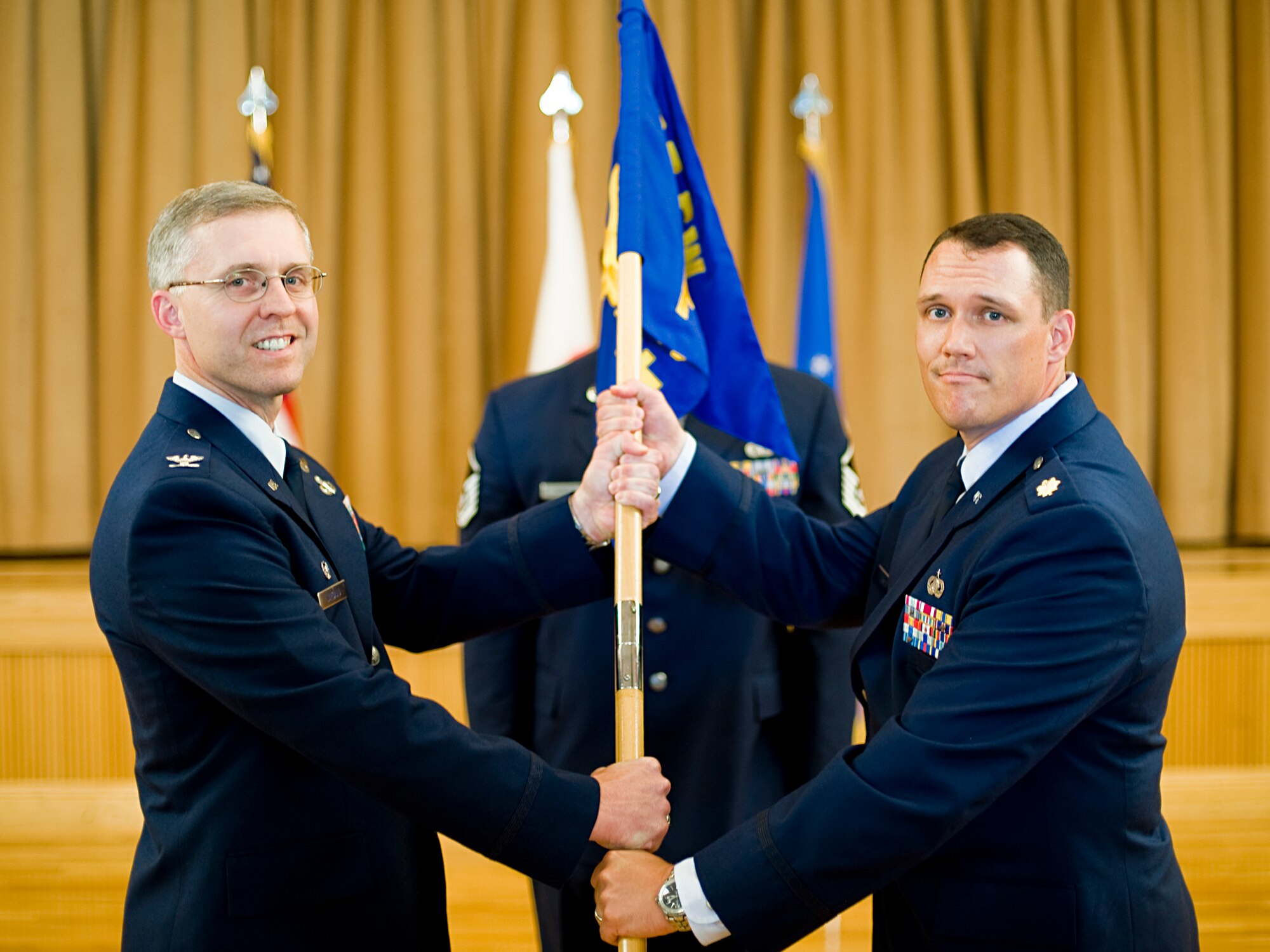 MISAWA AIR BASE, Japan -- Maj. Thomas Esser assumes command of the 35th Force Support Squadron as he receives the squadron guidon from Col. David Wiegand, 35th Mission Support Group commander, during an assumption of command ceremony July 12 at the Collocated Club. Major Esser comes from Yokota Air Base, Japan, where he served as the 374th Force Support Squadron deputy. (U.S. Air Force photo/Senior Airman Jamal D. Sutter)