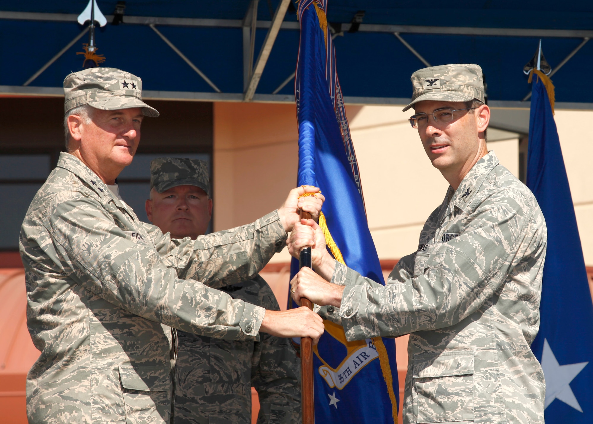 Col. Gregory E. Schwab, second from right, receives the 95th Air Base Wing guidon from Maj. Gen. David J. Eichhorn, Air Force Flight Test Center commander. Colonel Schwab assumed command during a formal Air Force ceremony July 9. (Air Force photograph by Stephen K. Robinson)