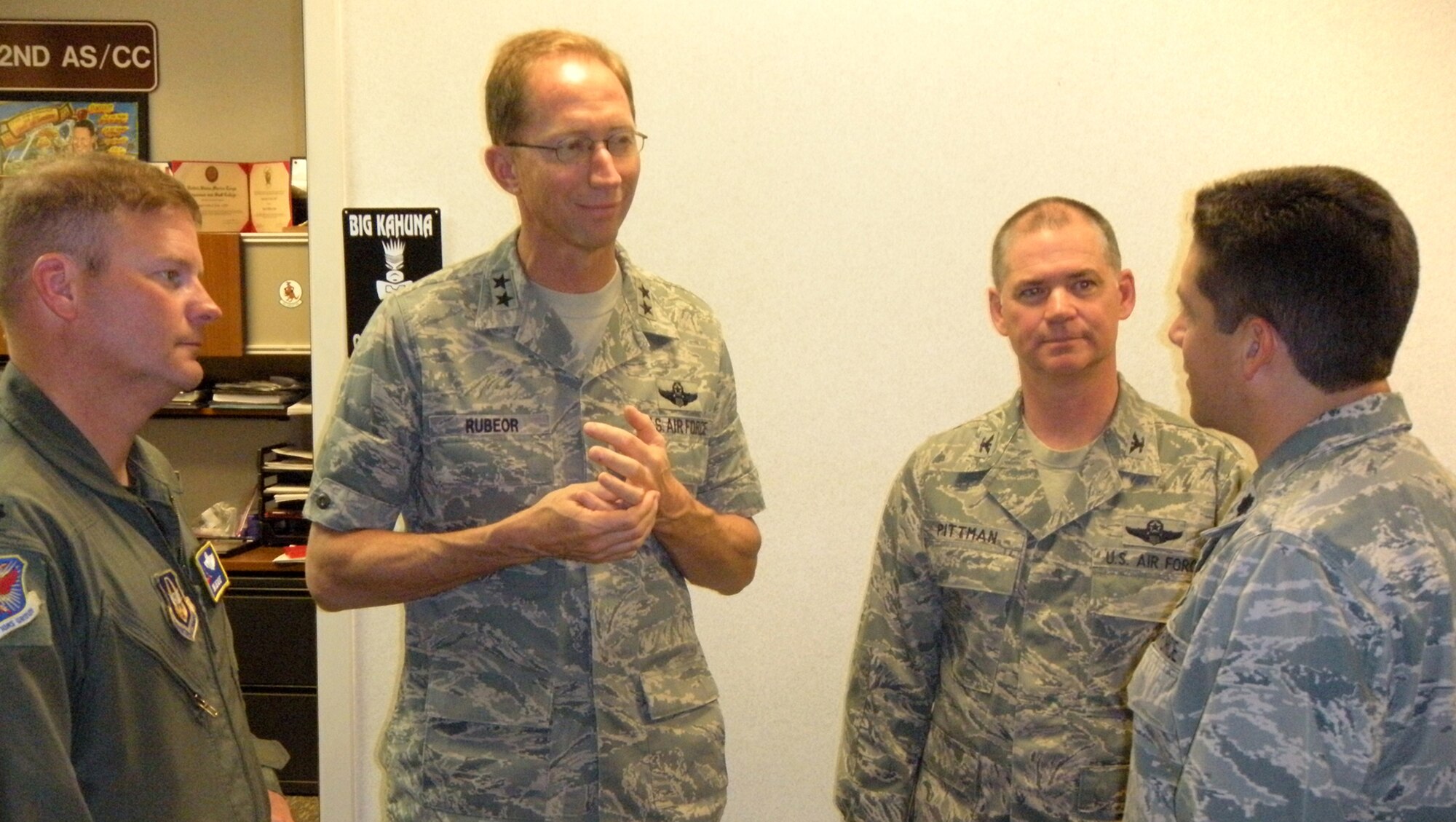 Maj. Gen. James T. Rubeor (second from left) talks with Lt. Col. Carlos Ortiz (far right) June 4 about the status of Total Force Integration between the Air Force Reserve's 302nd Airlift Wing and the Active Duty 52nd Airlift Squadron at Peterson Air Force Base, Colo. Col. Jay Pittman, Jr. (second from right), 302nd AW commander, and Lt. Col. James Devere, 302nd Operations Group deputy commander, are also present. General Rubeor, 22nd Air Force commander, visited the 302nd AW during the June Unit Training Assembly weekend to get a first-hand look at the many missions the wing supports. The 302nd AW is a subordinate unit to 22nd AF. Colonel Ortiz is the 52nd AS commander. (U.S. Air Force photo/Tech. Sgt. Daniel Butterfield) 